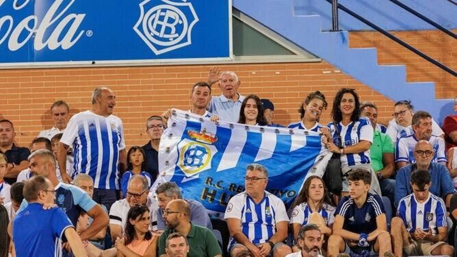 Aficionados del Recre posan con una bandera en el Nuevo Colombino.