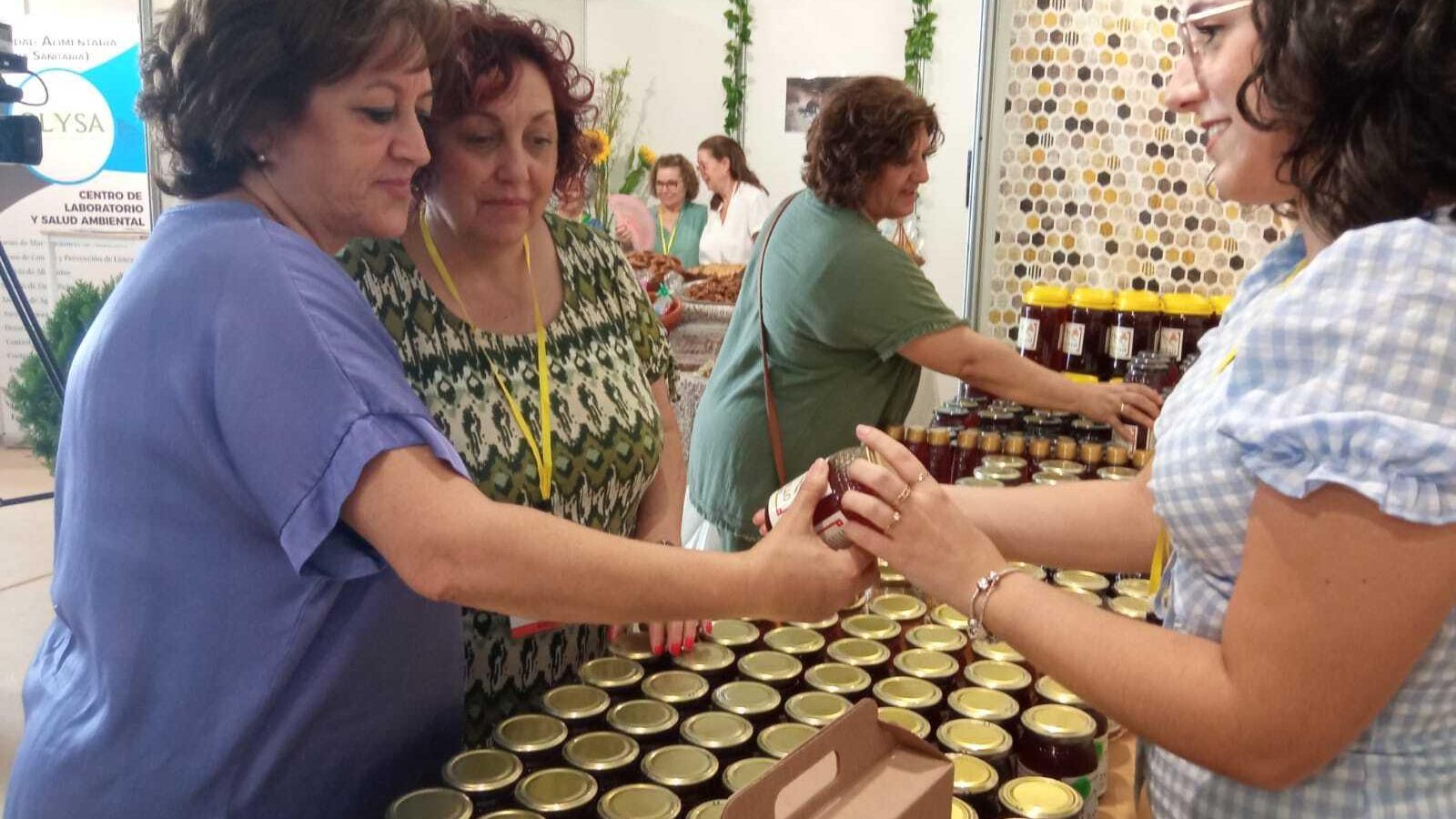 Dos mujeres se interesan por la producción de una de las empresas locales.