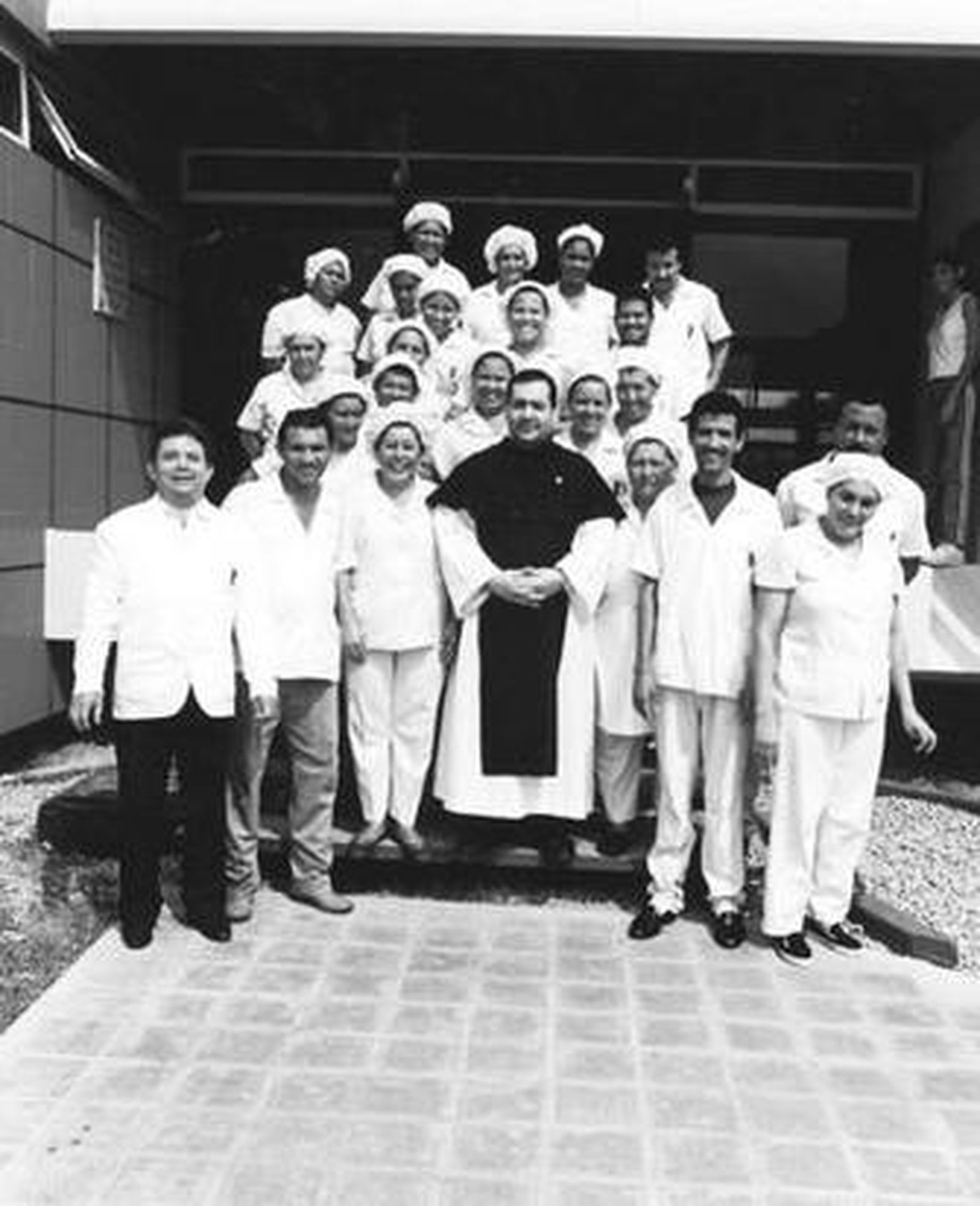 José Herrera (con hábito) posa junto a personal de Obreros de la Cruz en Venezuela en una imagen de archivo.