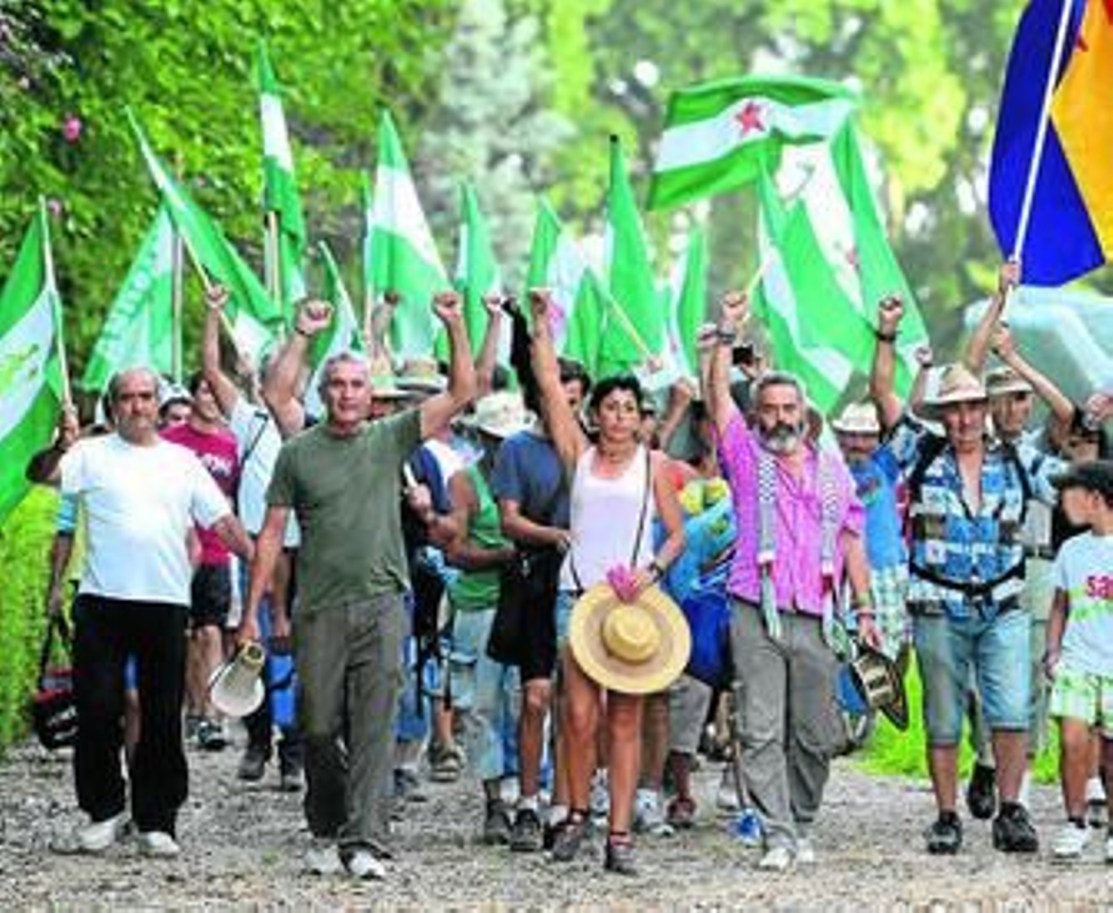 Sánchez Gordillo y su grupo de jornaleros abandonan ayer puño en alto el palacete de Hornachuelos.