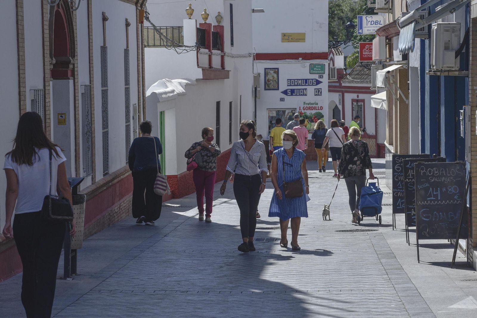 La céntrica calle Tomas Ybarra de Tomares, con sus carteles al fondo que indican las direcciones a Bormujos y San Juan.