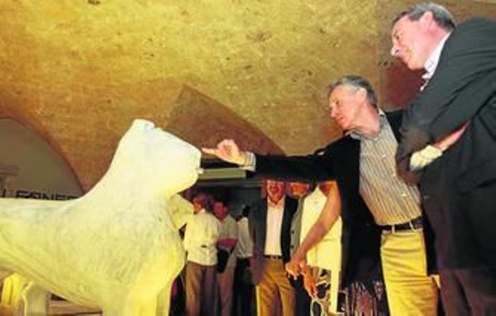 1. Paulino Plata y Francisco Álvarez de la Chica contemplan de cerca uno de los doce leones restaurados, en un día que consideraron histórico 2. Los leones se muestran ahora en una exposición visualmente muy atractiva por el juego de luces que se ha empleado. 3. El público quedó sorprendido con la muestra. 4. Los leones han vuelto a recuperar su color y su aspecto original. 5. Cada pareja de leones tiene unos rasgos propios.