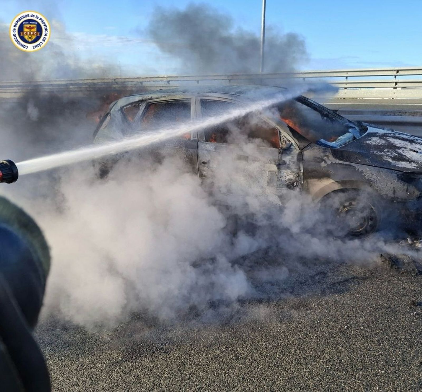 Coche ardiendo en el puente de la Constitución de Cádiz este domingo.