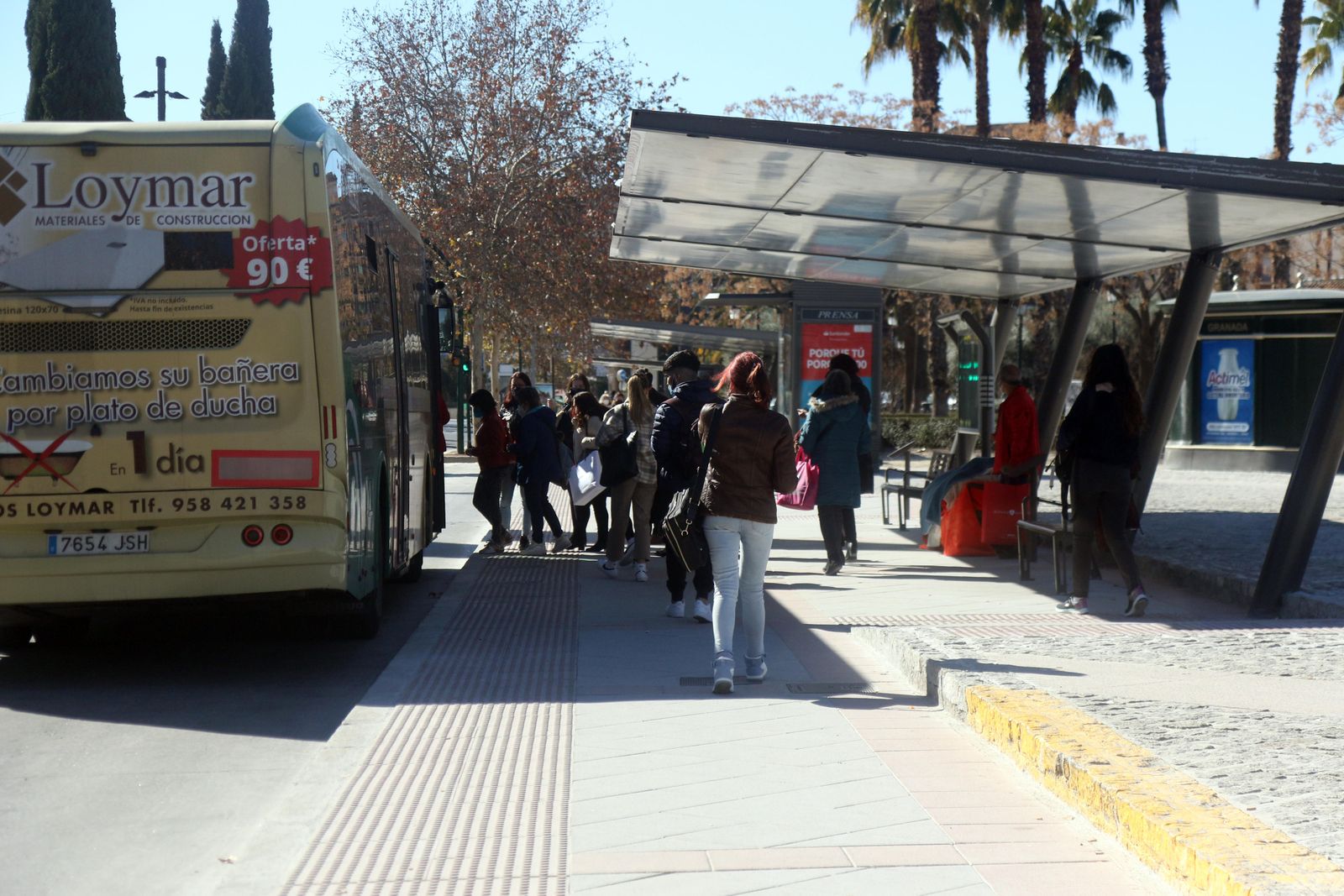 Un grupo de personas se dispone a tomar un bus metropolitano