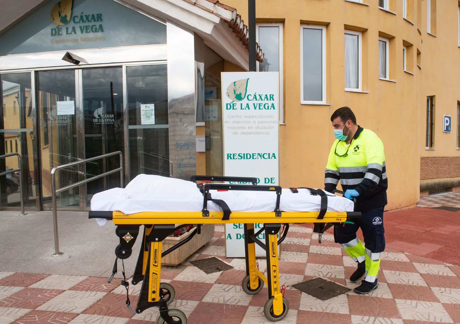 Personal sanitario traslada una camilla en la residencia  de mayores  de Cájar (Granada) donde se produjo un brote.
