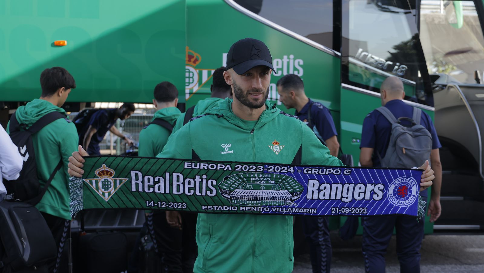 El defensa del Betis Germán Pezzella posa con una bufanda conmemorativa del partido que el Betis va a disputar ante el Rangers en el inicio de la Liga Europa.