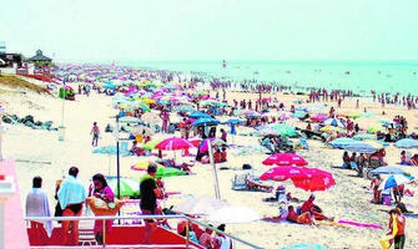 Bañistas llenan una playa de la costa onubense.