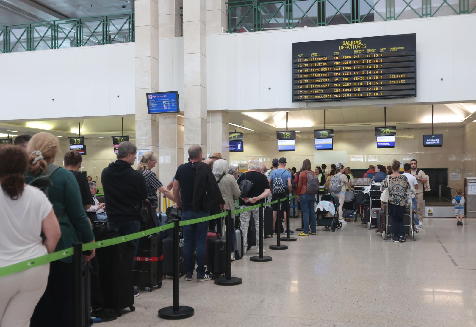 Viajeros de un pasajero con destino a Alemania en la cola de facturación del Aeropuerto de Jerez.