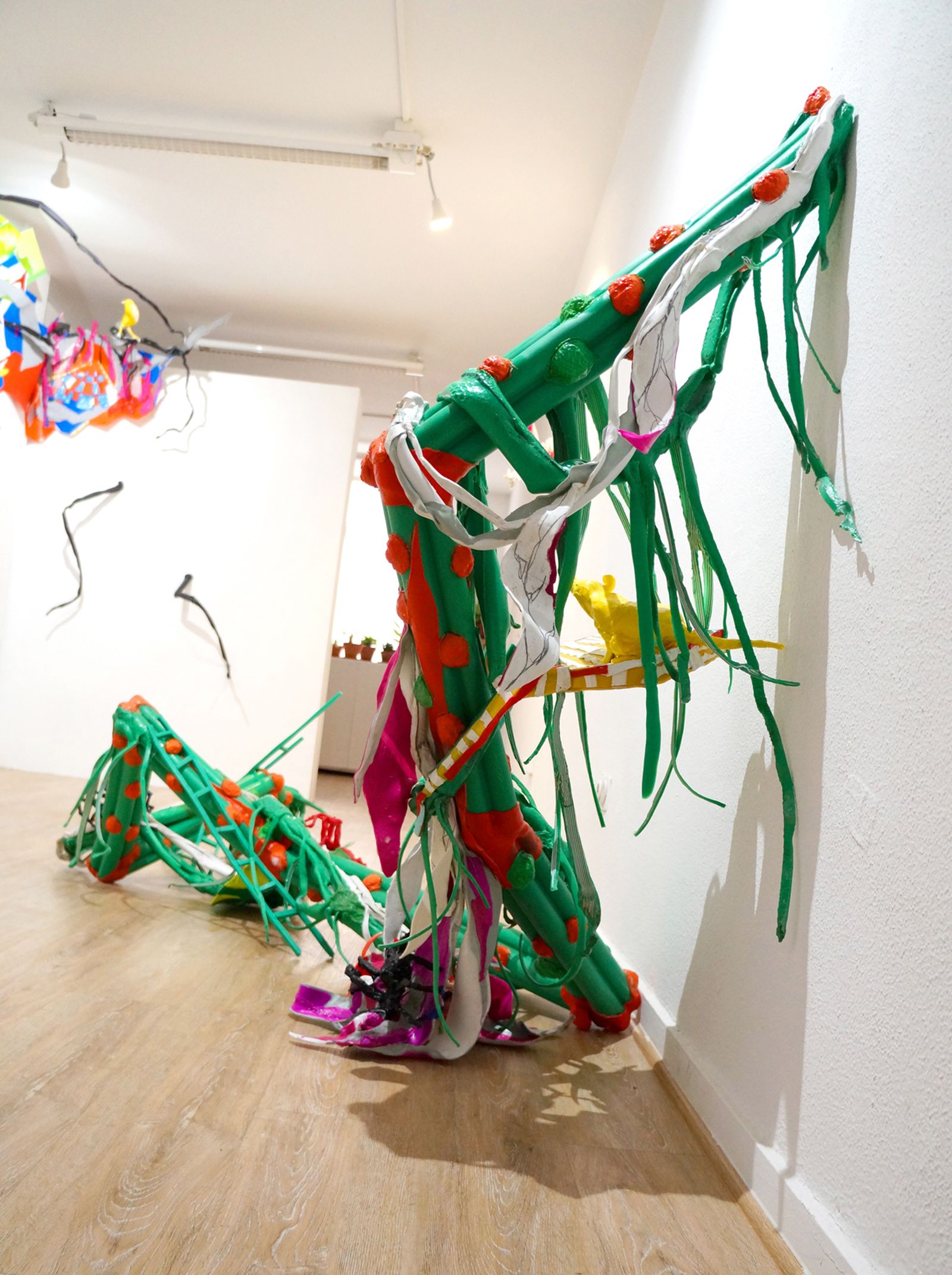 La instalación recorre las paredes de la galería simulando un bosque