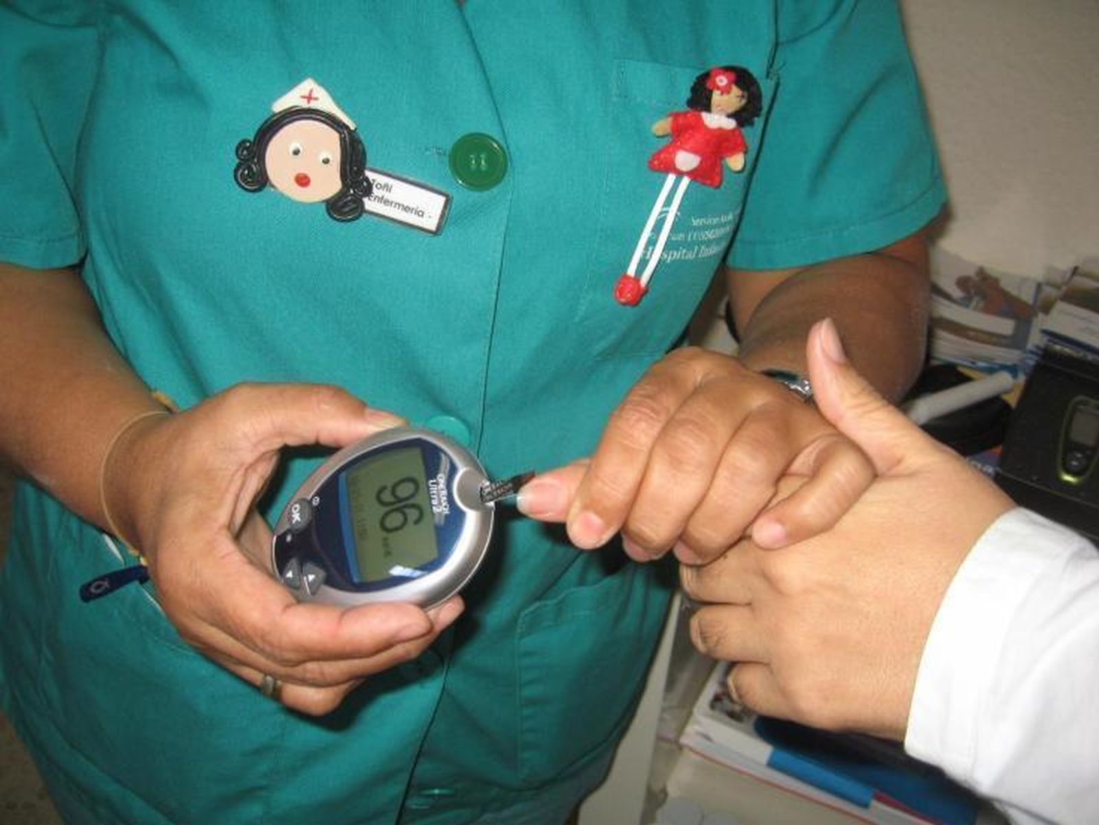 Una enfermera realiza un test de azúcar en sangre a una paciente.