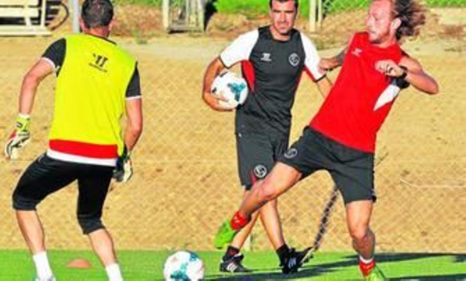 Ivan Rakitic disputa un balón ante Javi Varas durante un ensayo en la ciudad deportiva.