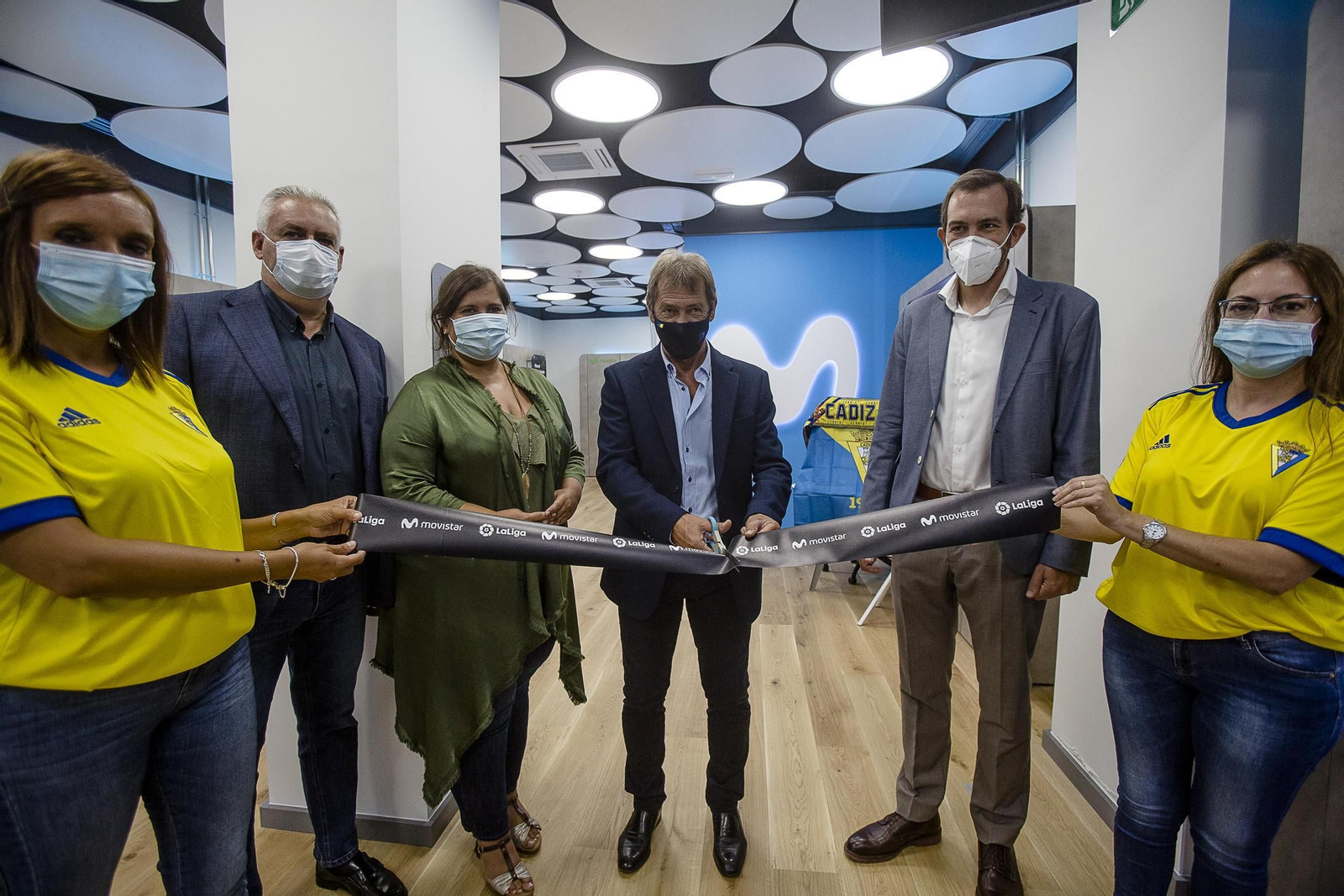 Momento en el que el futbolista Pepe Mejías corta la cinta inaugural de la nueva tienda.