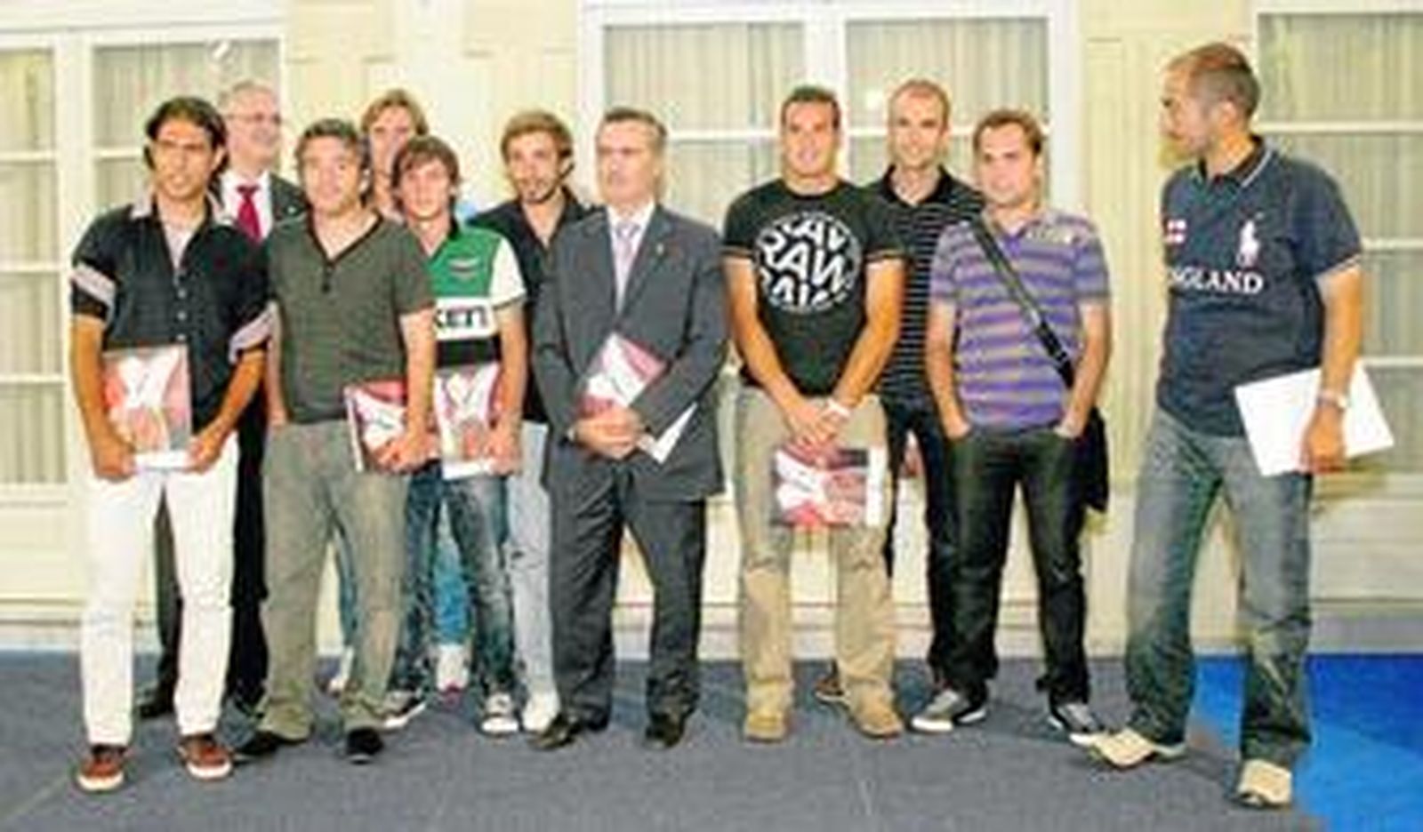 1. Los jugadores y el cuerpo técnico del Almería posaron junto a Juan Carlos Usero y José Juan Bonillo, en la foto de familia. 2. Un aficionado rojiblanco aprovecha la ocasión para que sus ídolos le firmen '3 años en la élite'. 3. Juanma Lillo, técnico del Almería, charla y recuerda anécdotas de los partidos junto a sus jugadores Hernán Bernardello y Pablo Piatti. 4. Juan Carlos Usero y José Juan Bonillo ojean algunas de las páginas del libro.