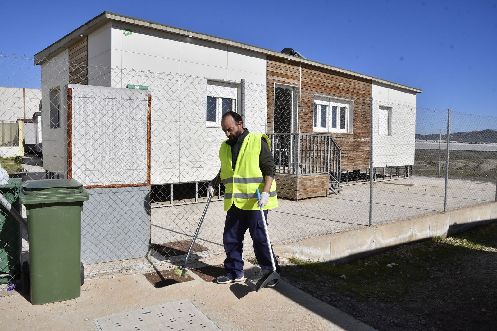 Un trabajador limpia las instalaciones de Los Grillos en las que se ha acogido a los inmigrantes.