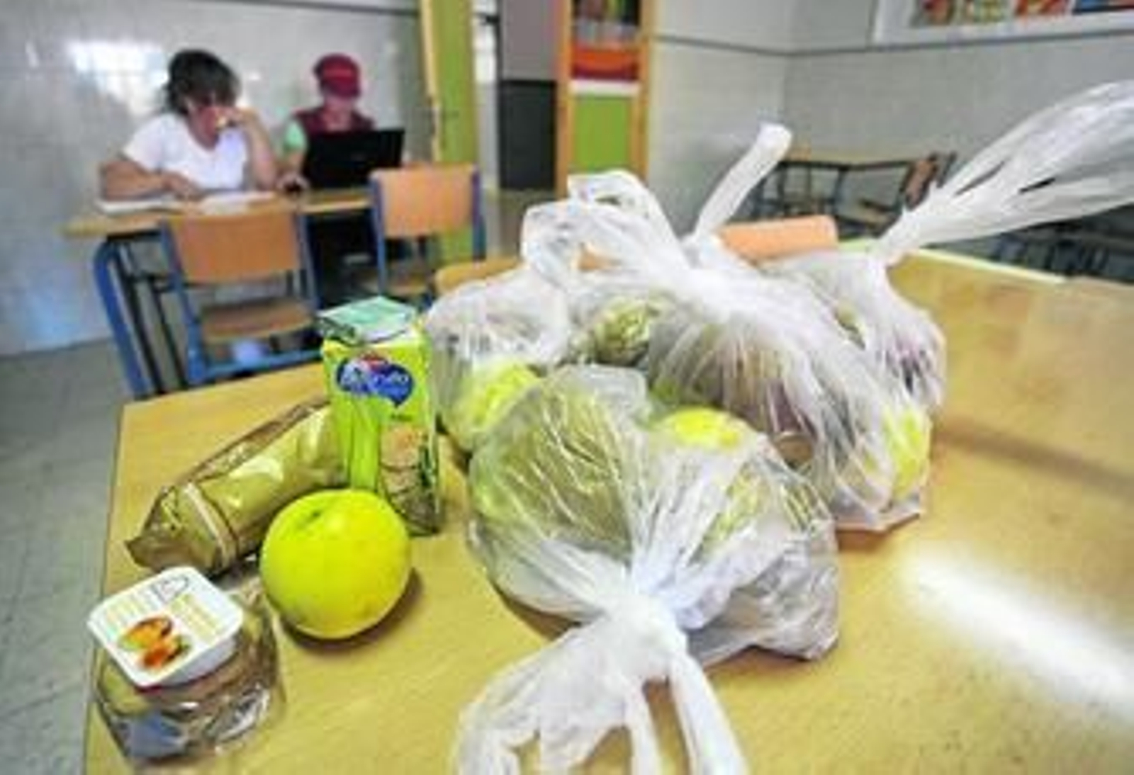 Bolsas con piezas de fruta, zumos y galletas ofrecidas a los niños el curso pasado.