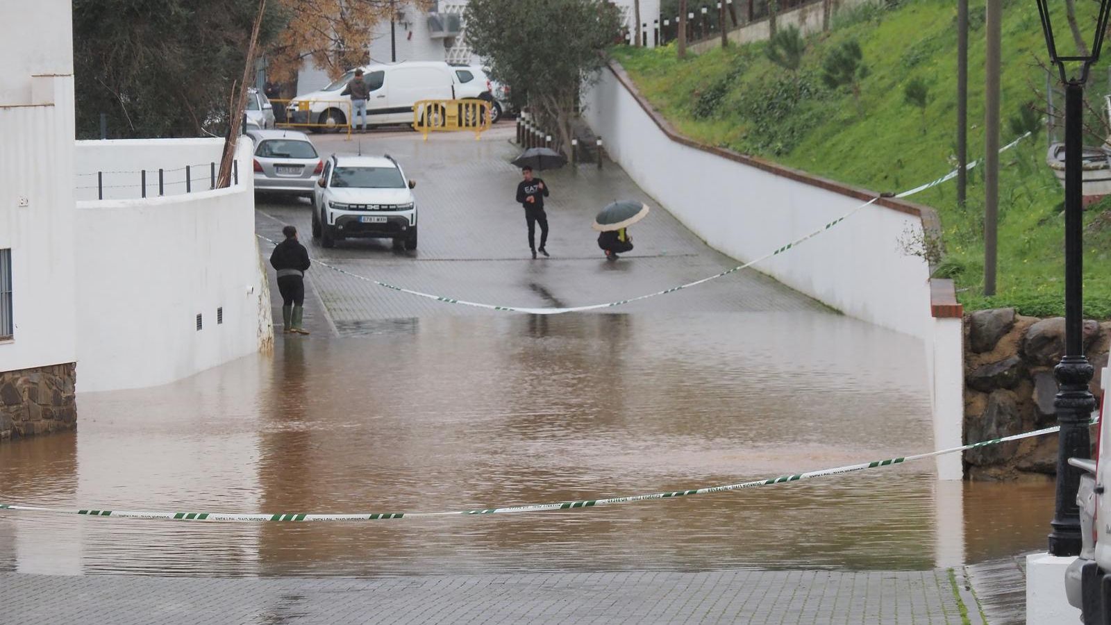 Personas paseando ante el desborde del río Guadiana.