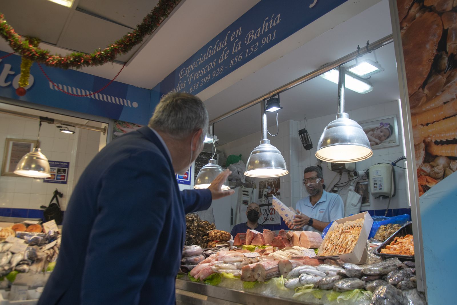El concejal Antonio Rojas saluda a un pescadero del Mercado de San Antonio.