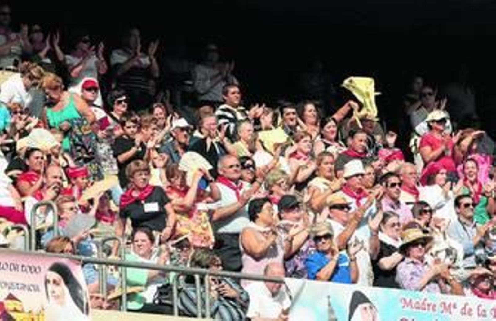 Devotos, que tuvieron que recurrir a los abanicos para sofocar el calor,  aplauden en uno de los momentos de la beatificación.