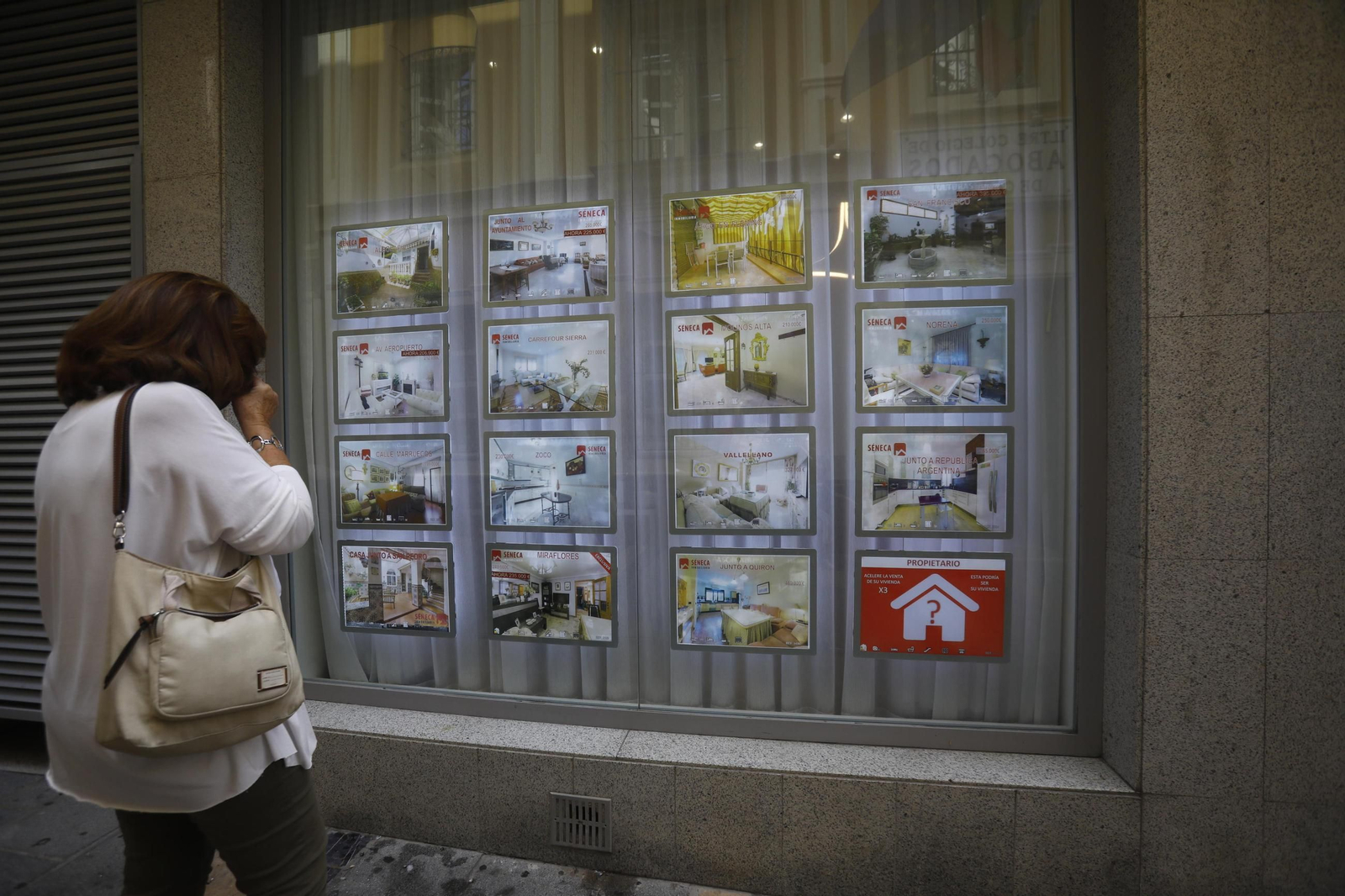 Una mujer observa los anuncios de una inmobiliaria de Córdoba capital.
