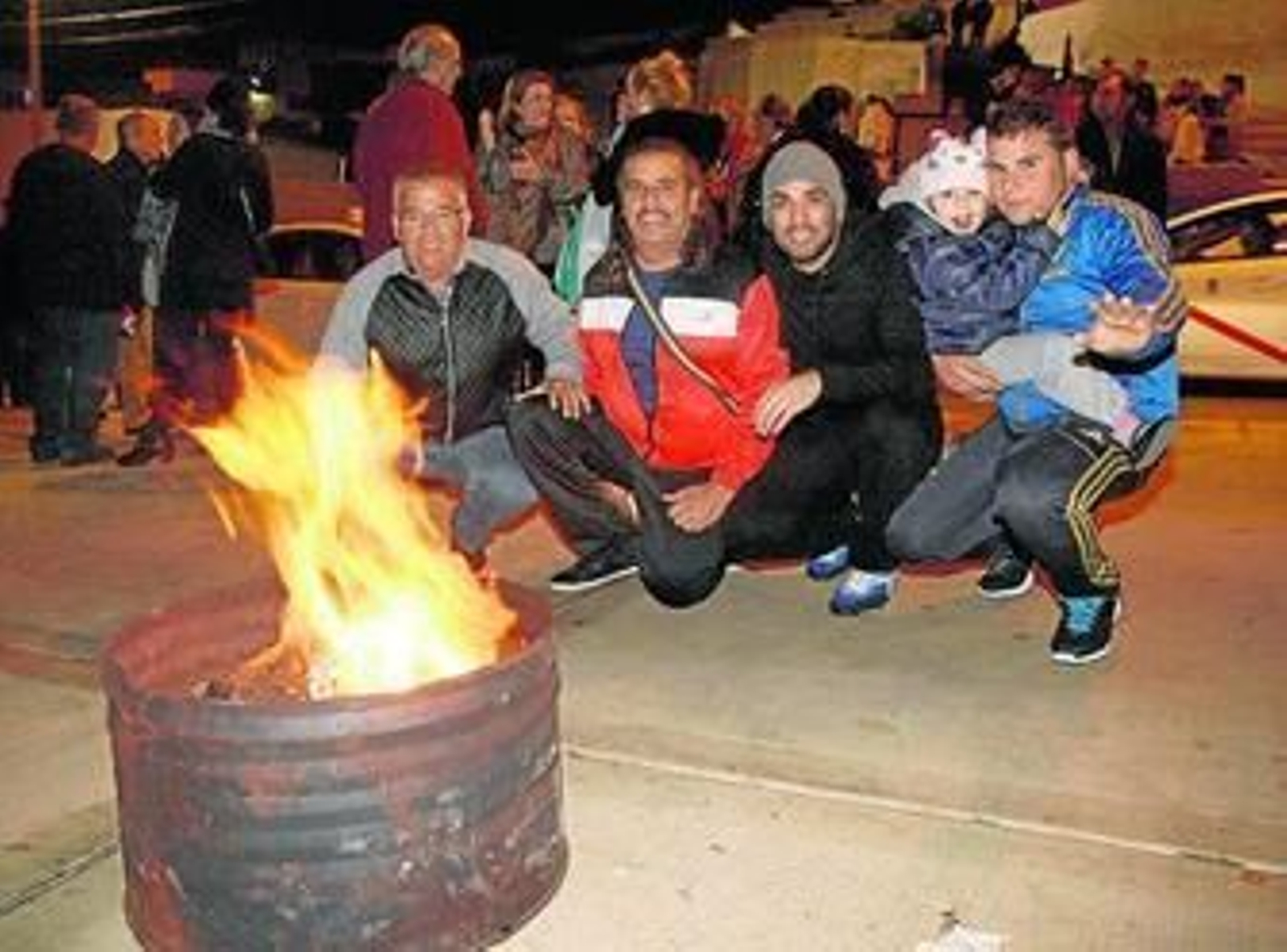 Un grupo de amigos se calienta junto a una buena candela.