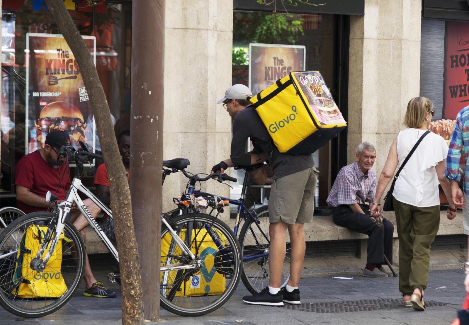 Varios repartidores en una calle.