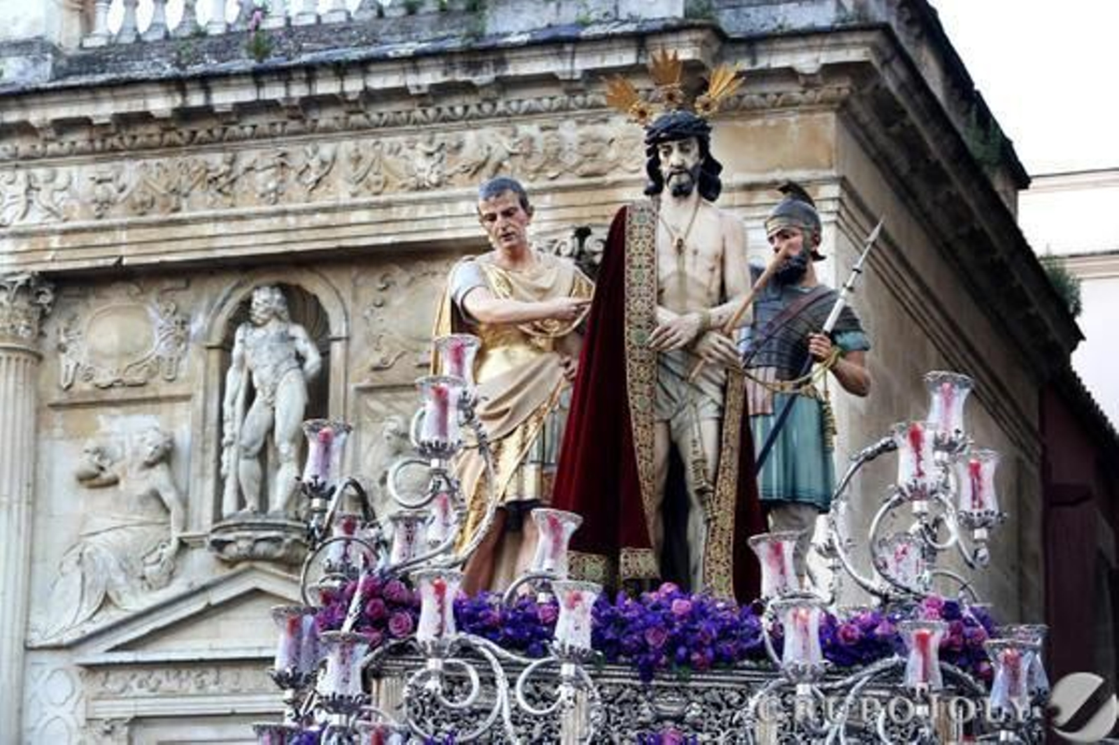 El Ecce Homo se recorta ante la efigie de Hércules que preside uno de los dinteles del Cabildo Viejo.

Foto: Pascual