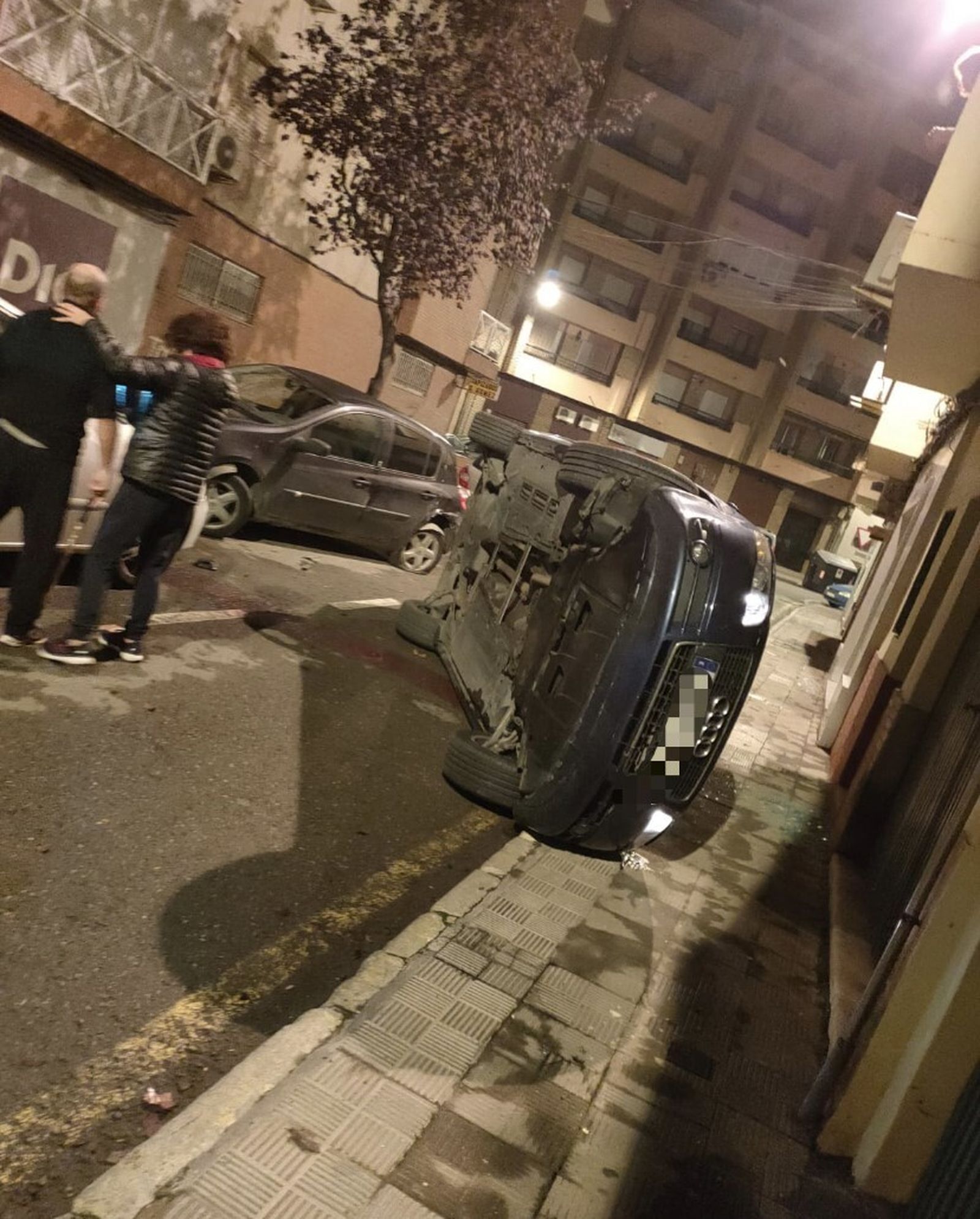Un conductor choca contra dos coches aparcados, vuelca y huye corriendo