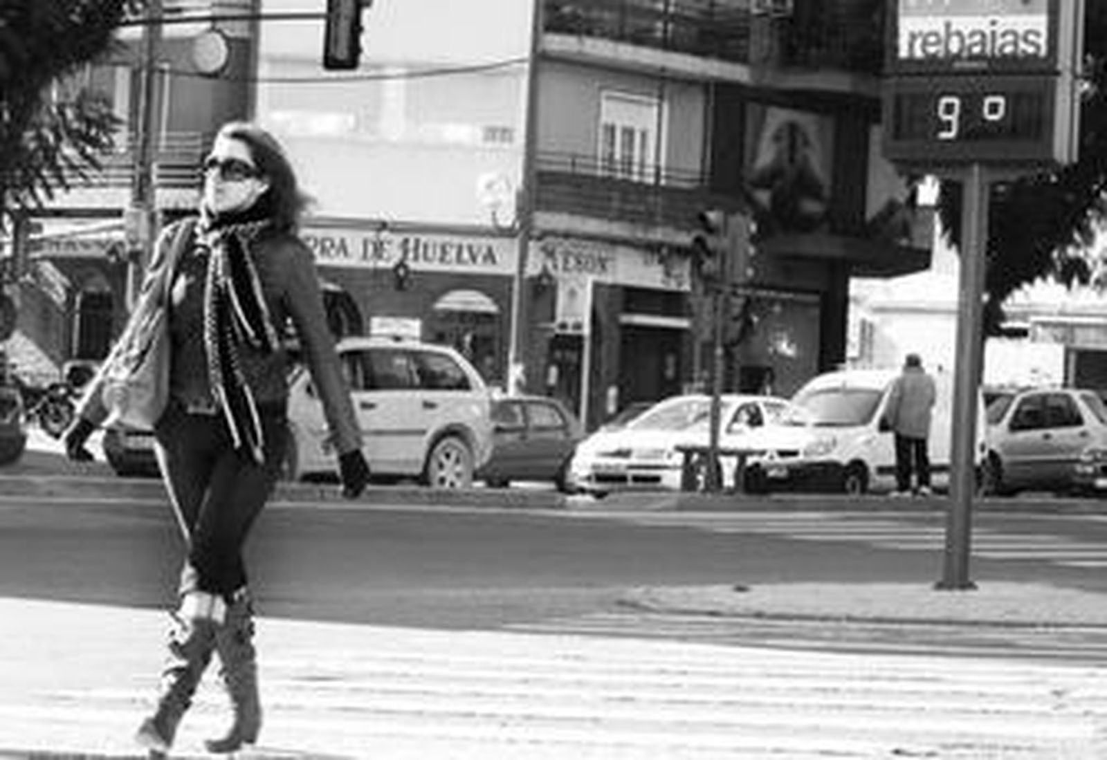 Una mujer camina bien abrigada por la avenida Luis Montoto de Nervión.