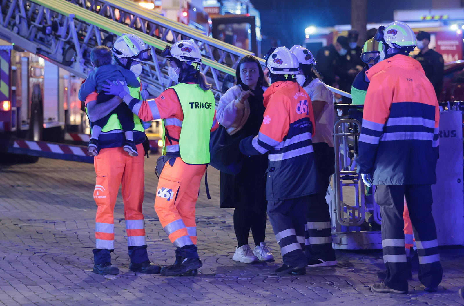 Sanitarios del 061 atienden al bebé y su madre, afectados por inhalación de humo en el hotel Isla Cartuja.