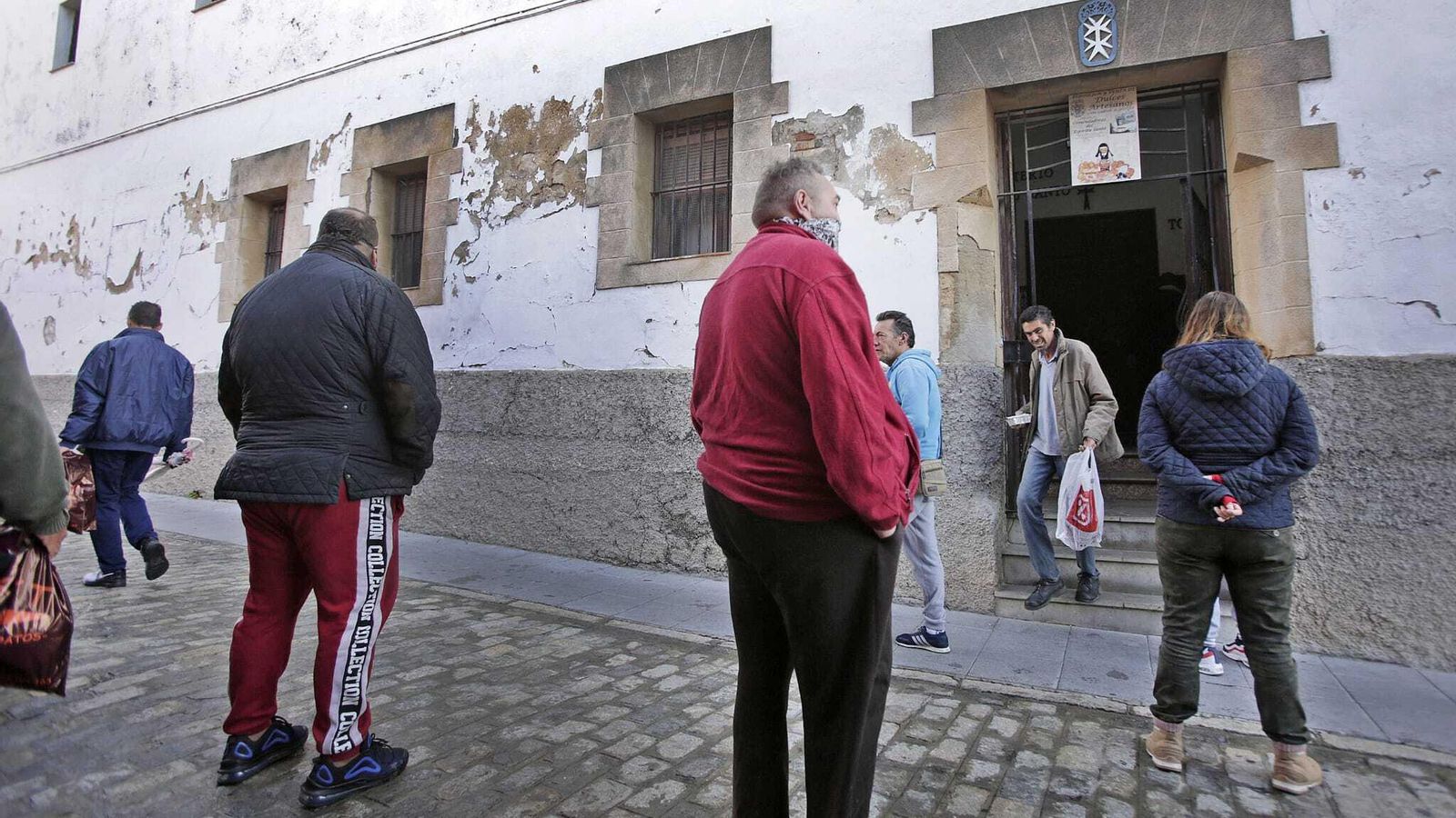 Un grupo de personas, esperando a las puertas del convento del Espíritu Santo.