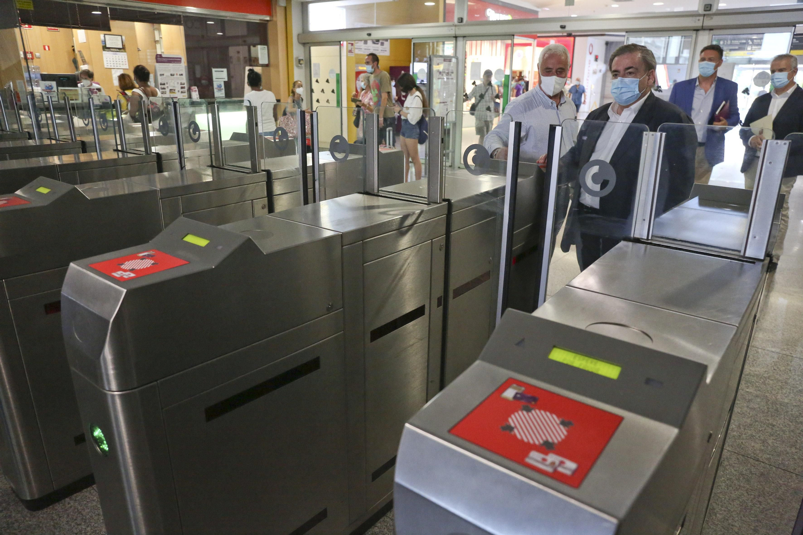 Usuarios entrando en los tornos del Cercanías en la estación María Zambrano.