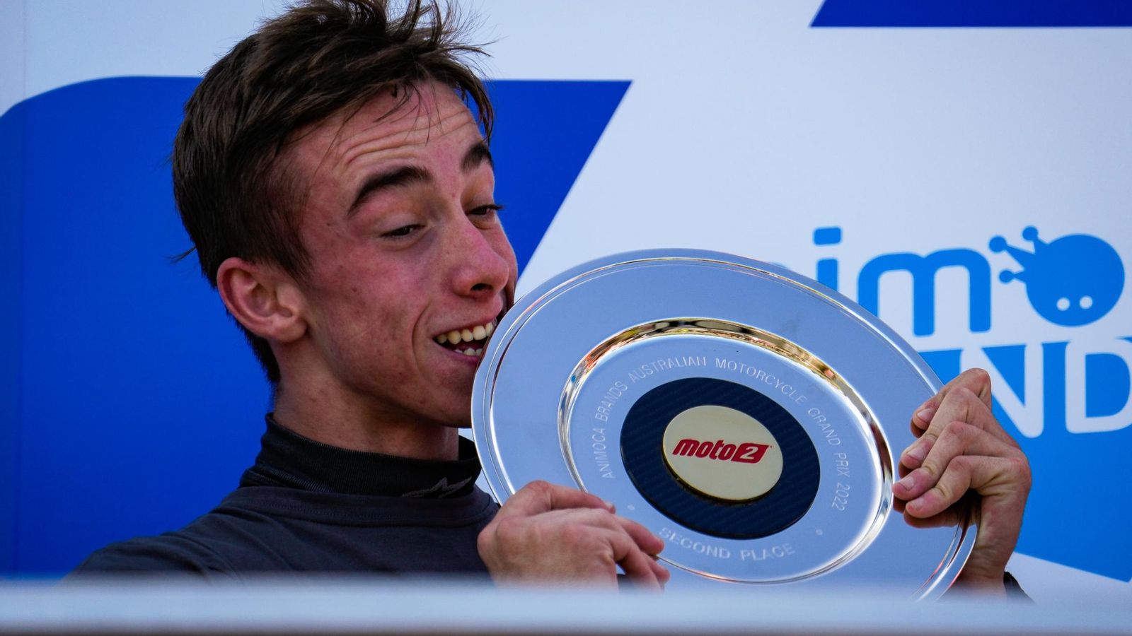 Acosta muerde el trofeo como segundo en el GP de Australia.