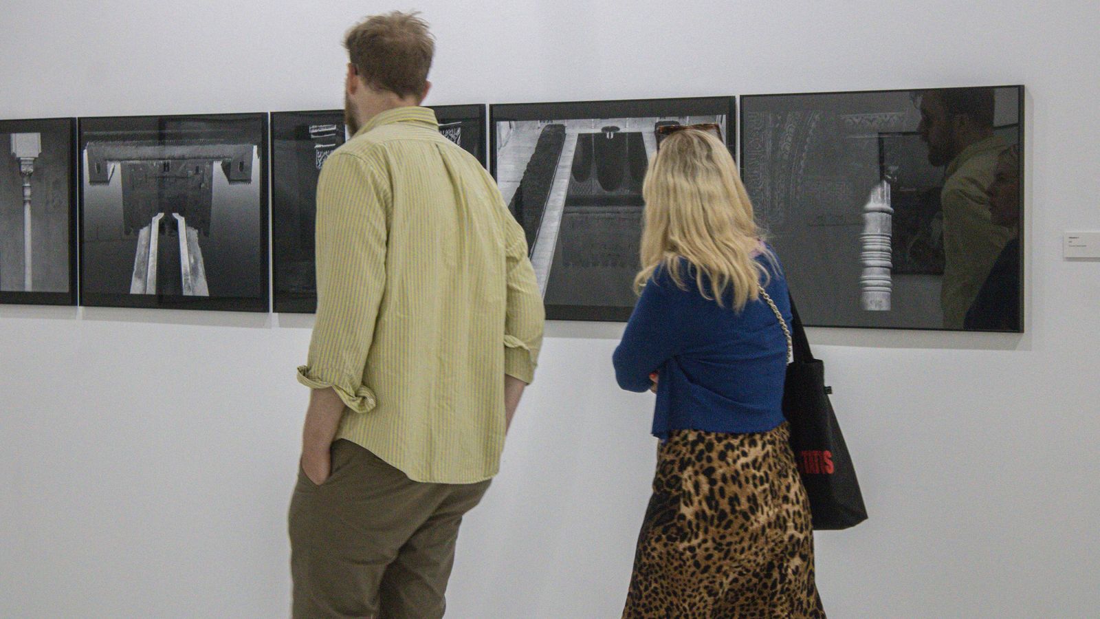 Unos visitantes contemplan las imágenes.