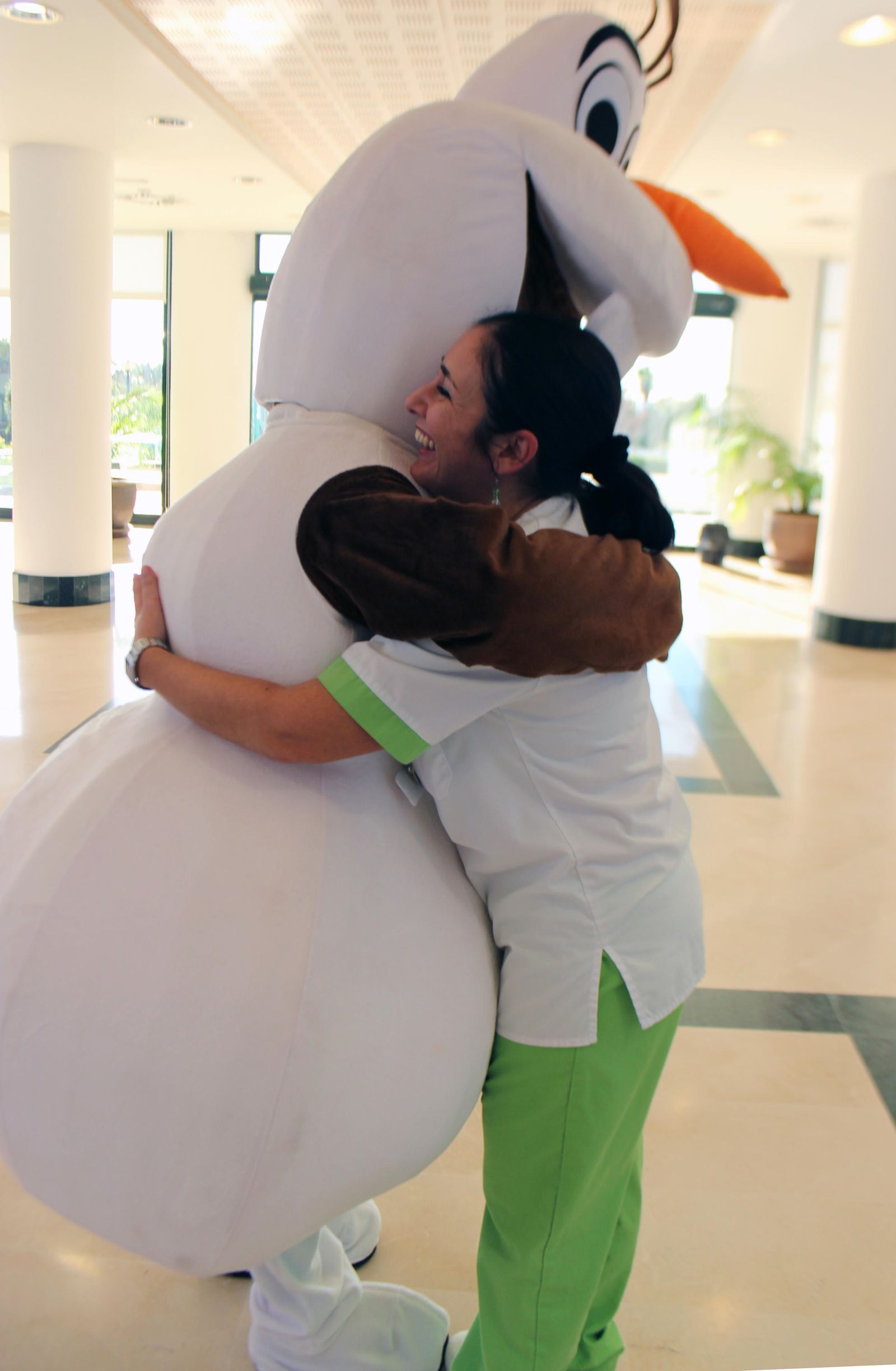 Una empleada abraza a una persona disfrazada de Olaf en esta campaña.