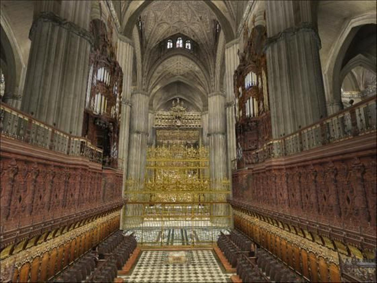 Sillería del coro con el retablo Mayor al fondo.
