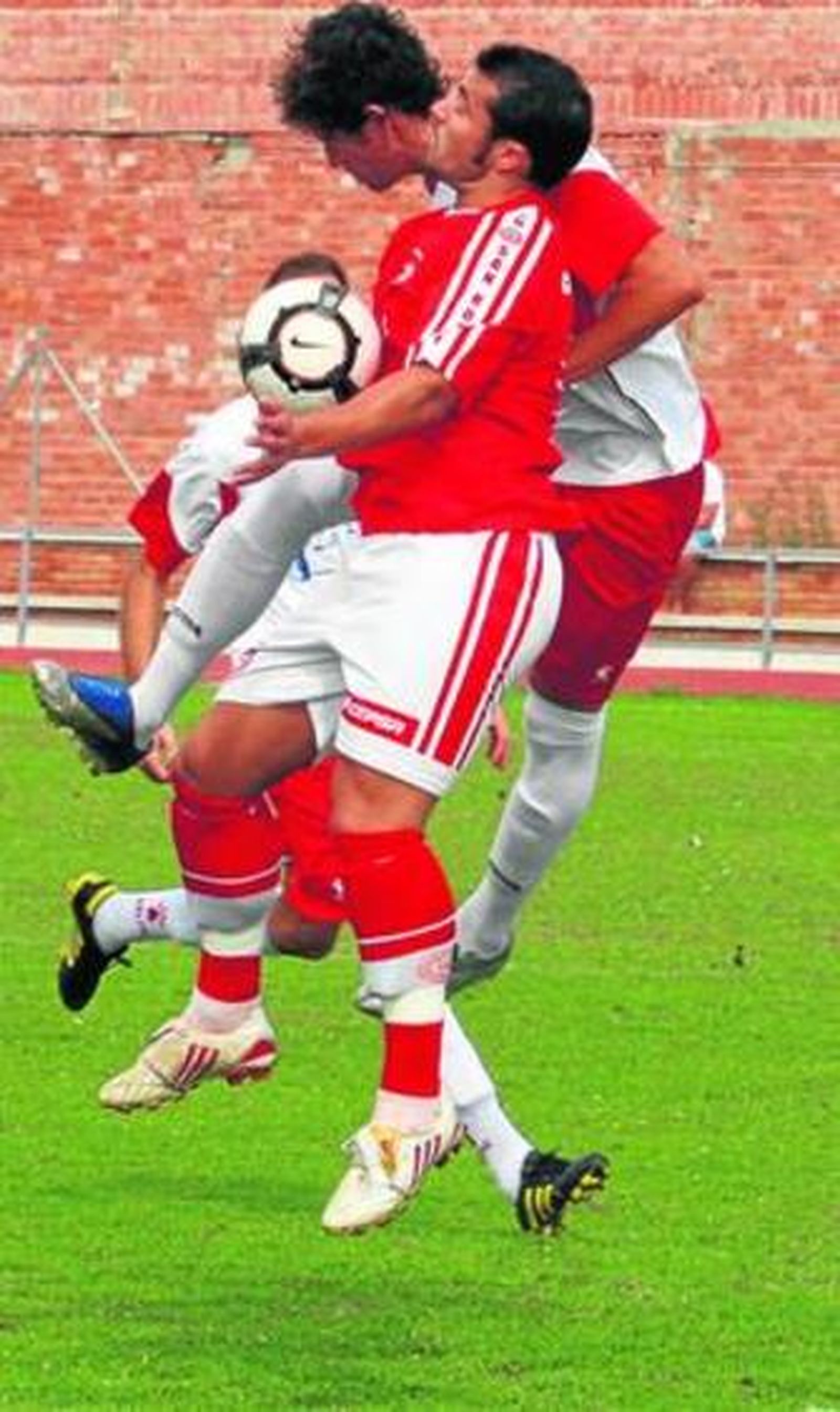 Adrián Cabello lucha un balón aéreo con un contrario.