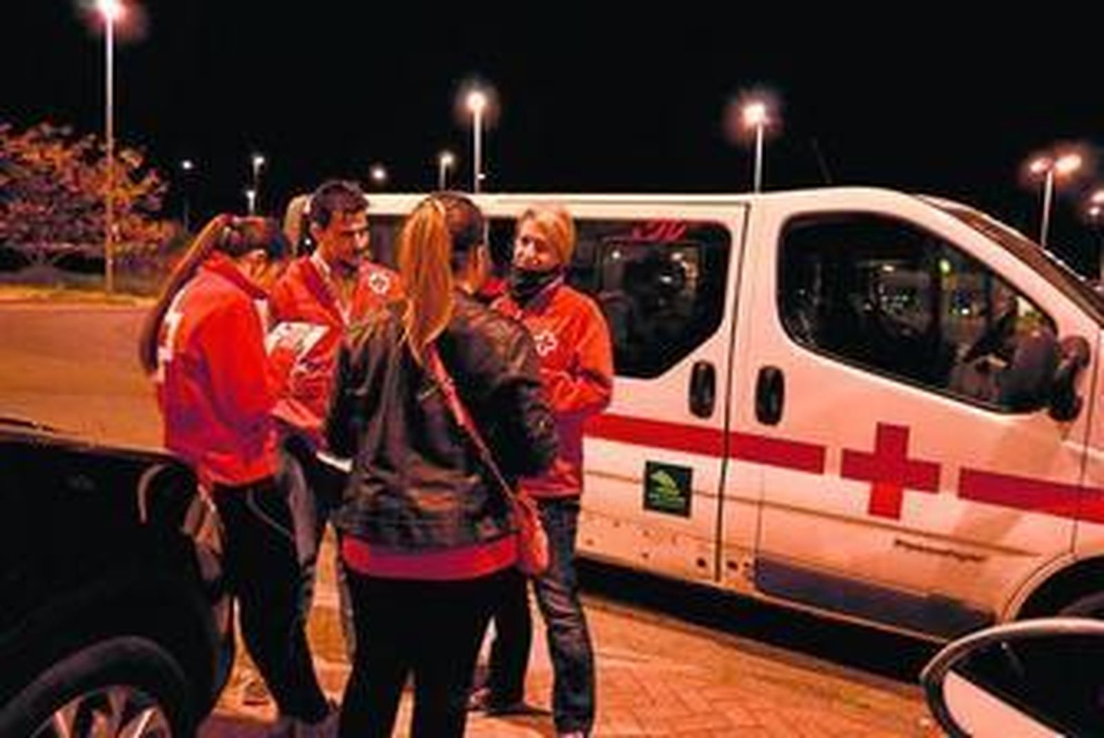 Trabajadores de Cruz Roja atienden a una mujer.