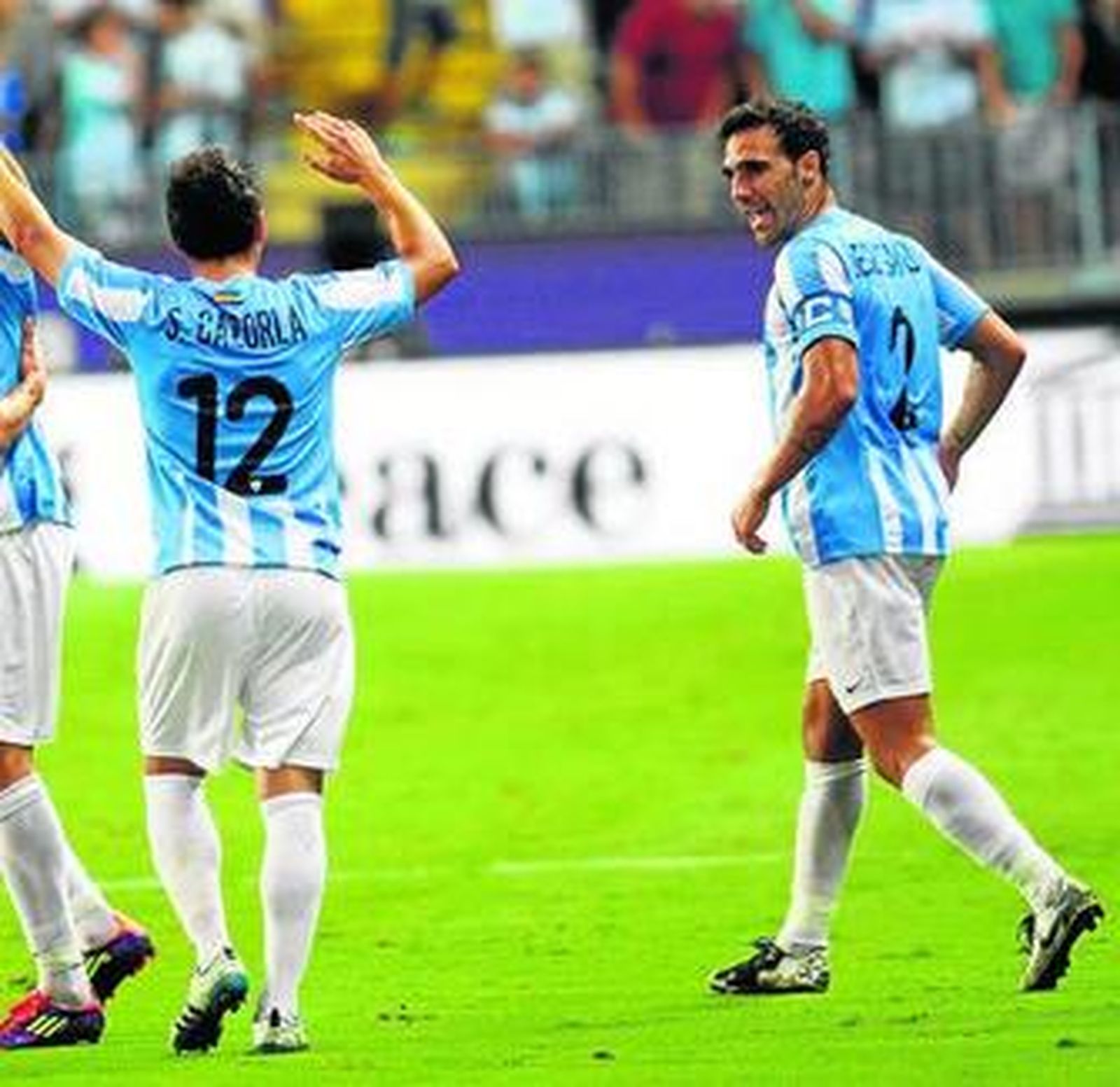 Jesús Gámez felicita a Cazorla tras el gol de éste.