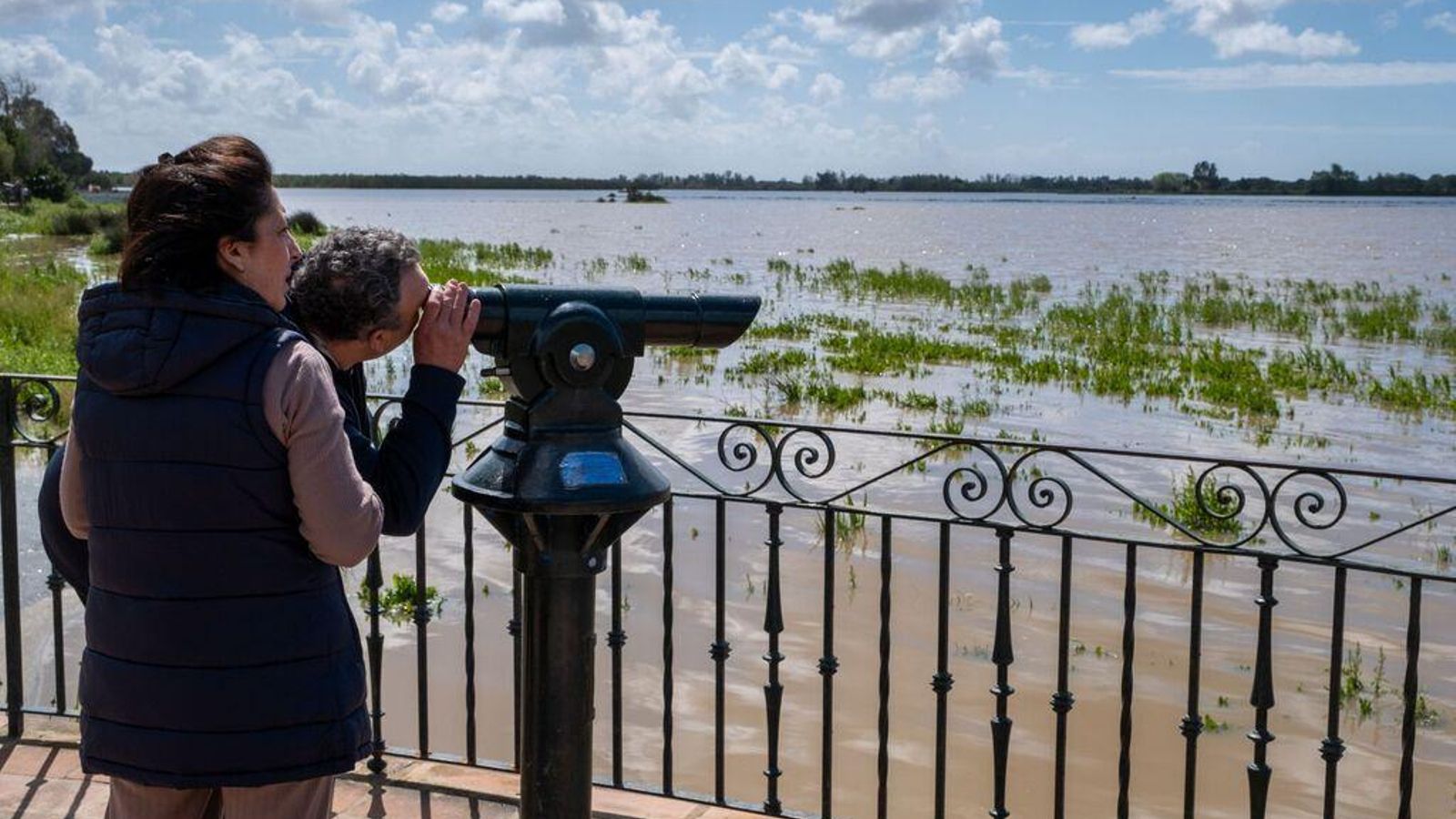 Dos personas observan las lagunas de Doñana.