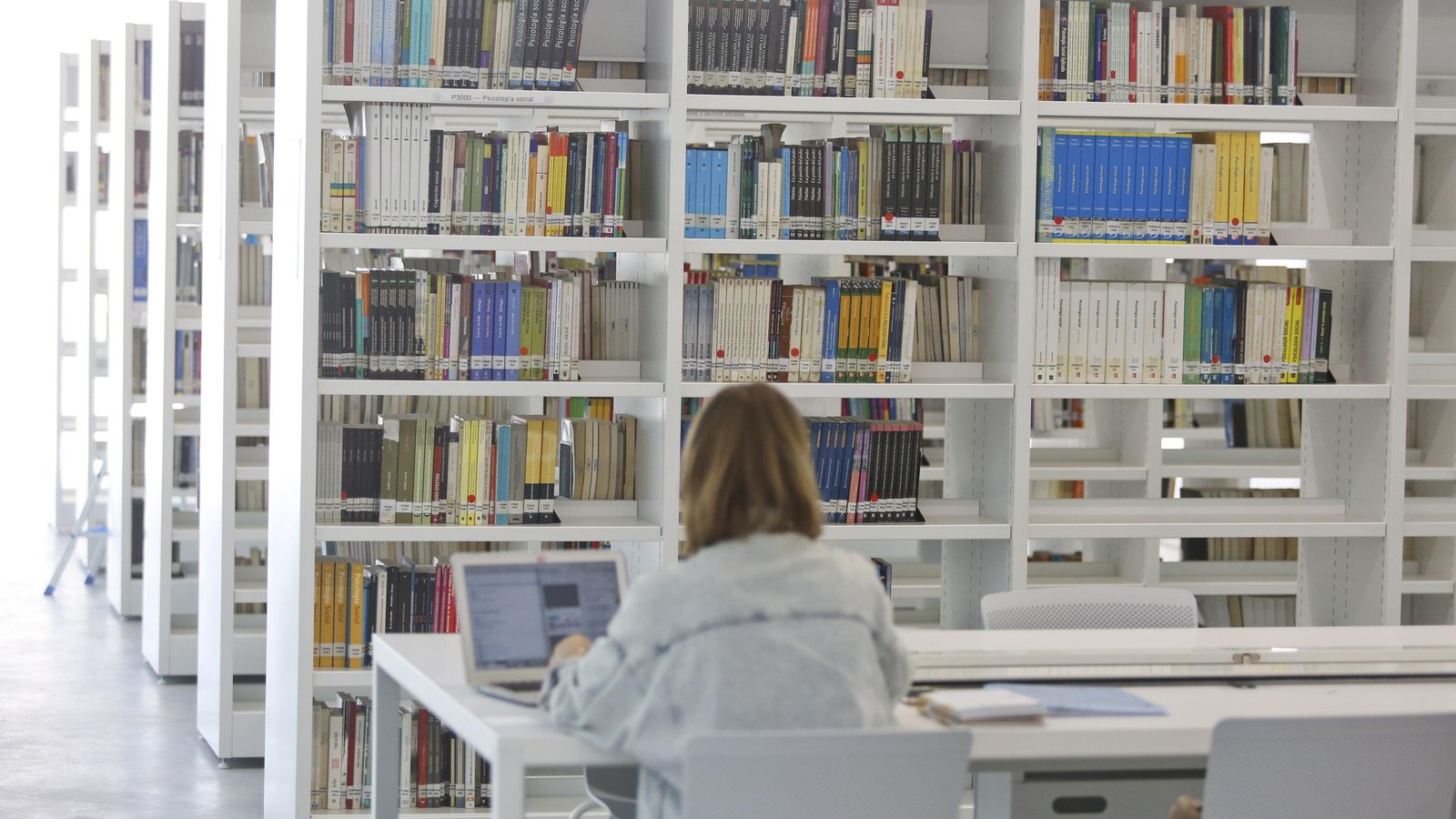 Una alumna en la biblioteca.