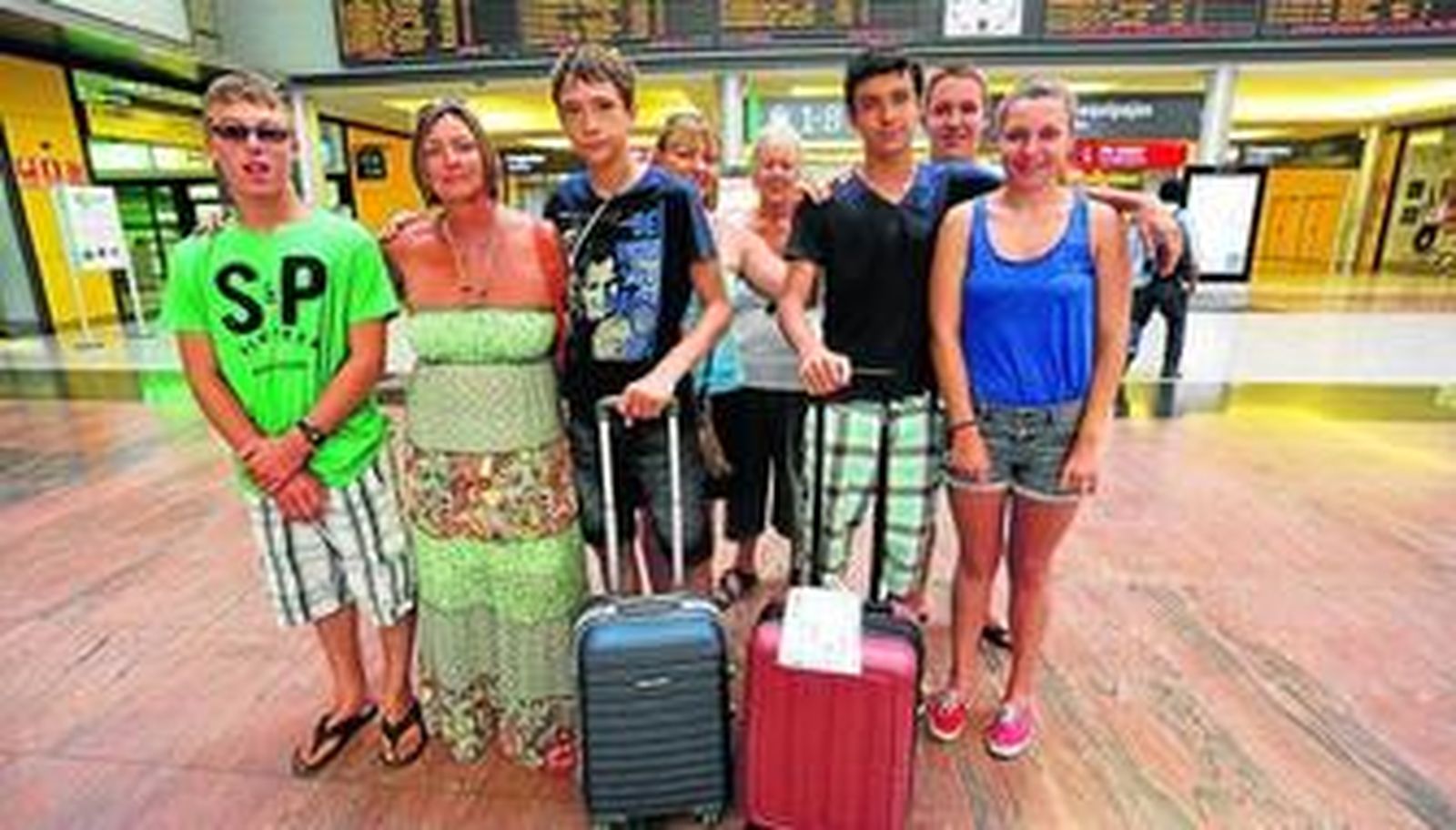 Pedro y Guille, con sus maletas, junto a una de las familias con las que han pasado dos semanas en Málaga.