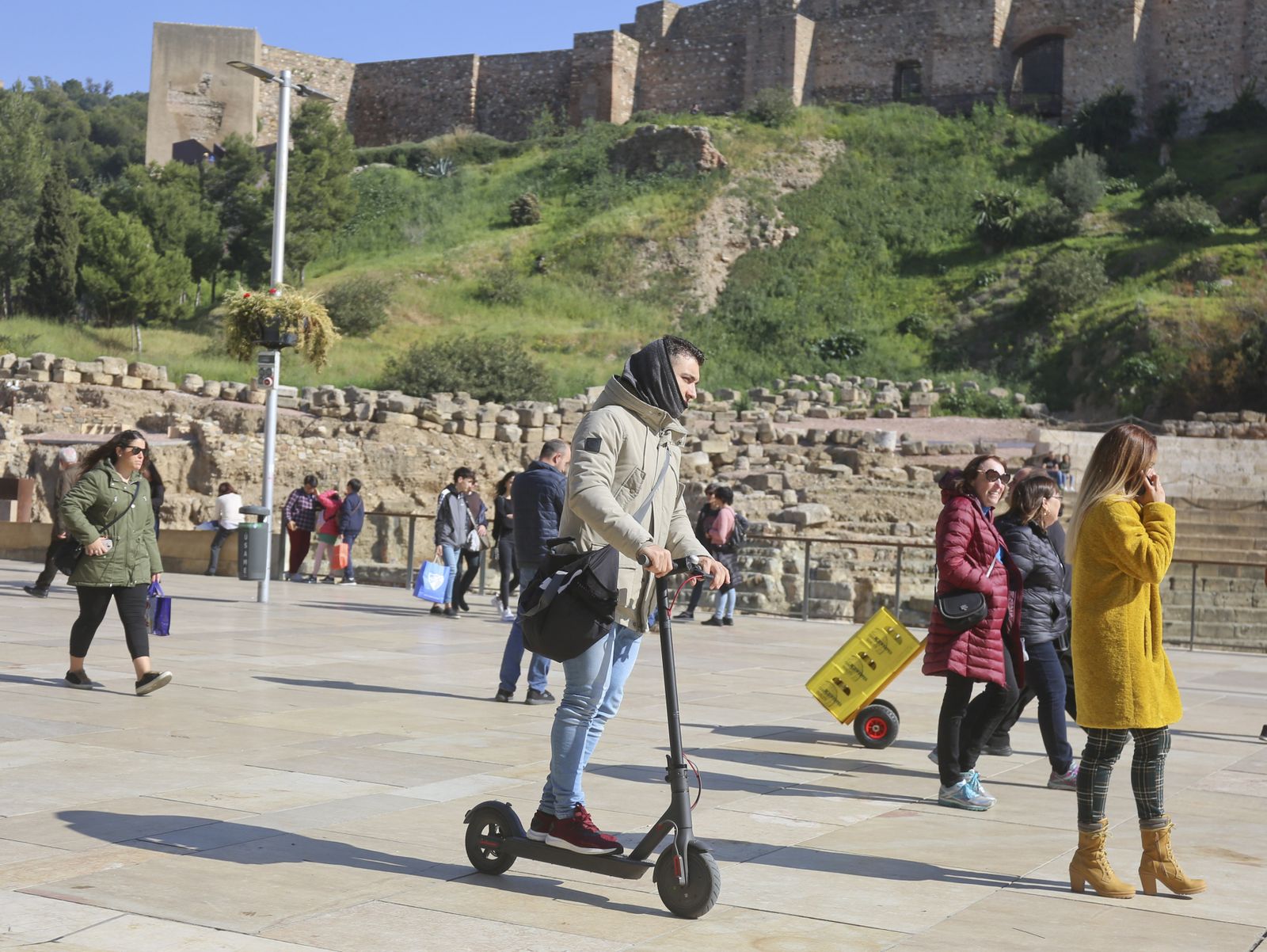 Un joven circula en patinete eléctrico por la calle Alcazabilla.