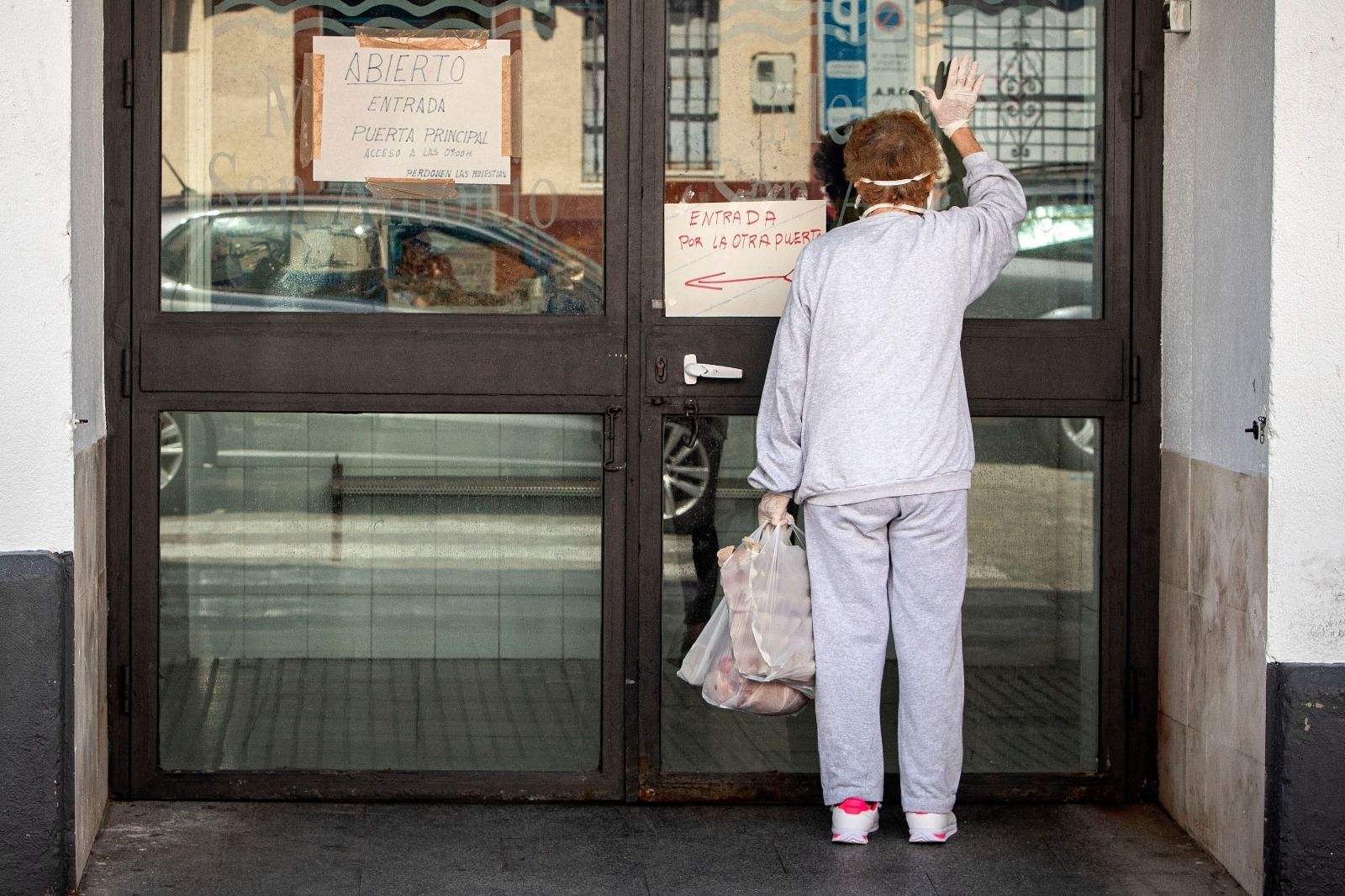 Una señora en la puerta del Mercado de San Antonio.