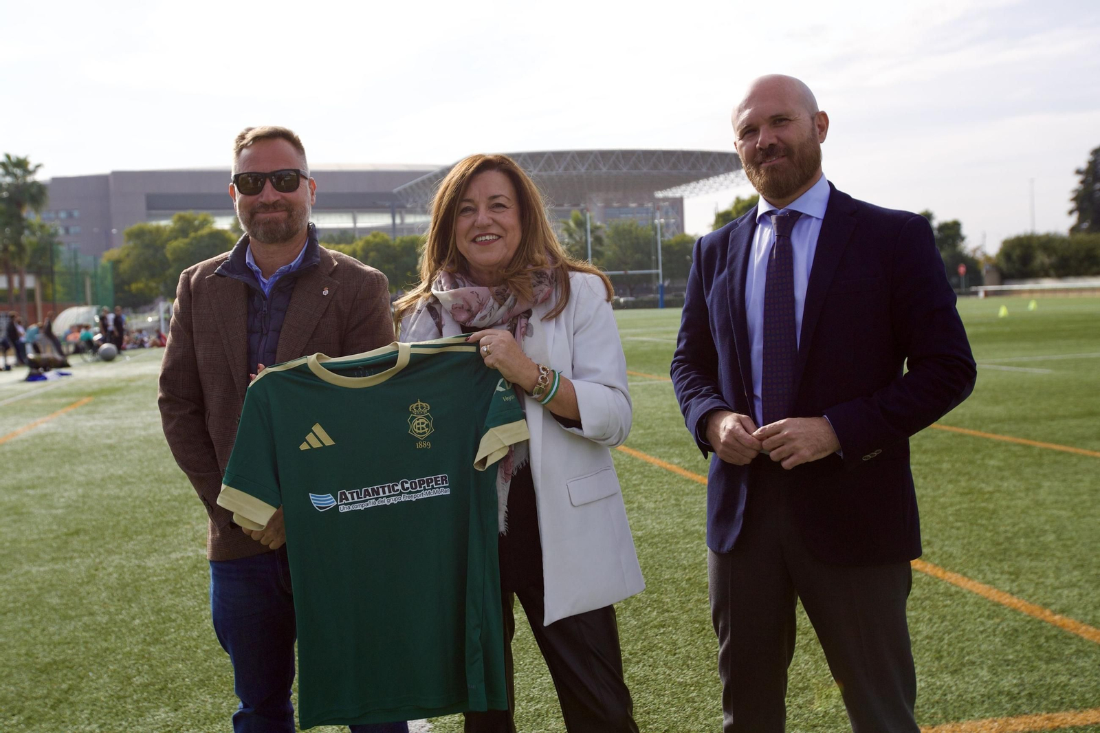 David Ortega (a la izquierda), en representación del Recreativo de Huelva, posa junto a la consejera de Desarrollo Educativo y Formación Profesional, María del Carmen Castillo, con una camiseta del Decano.