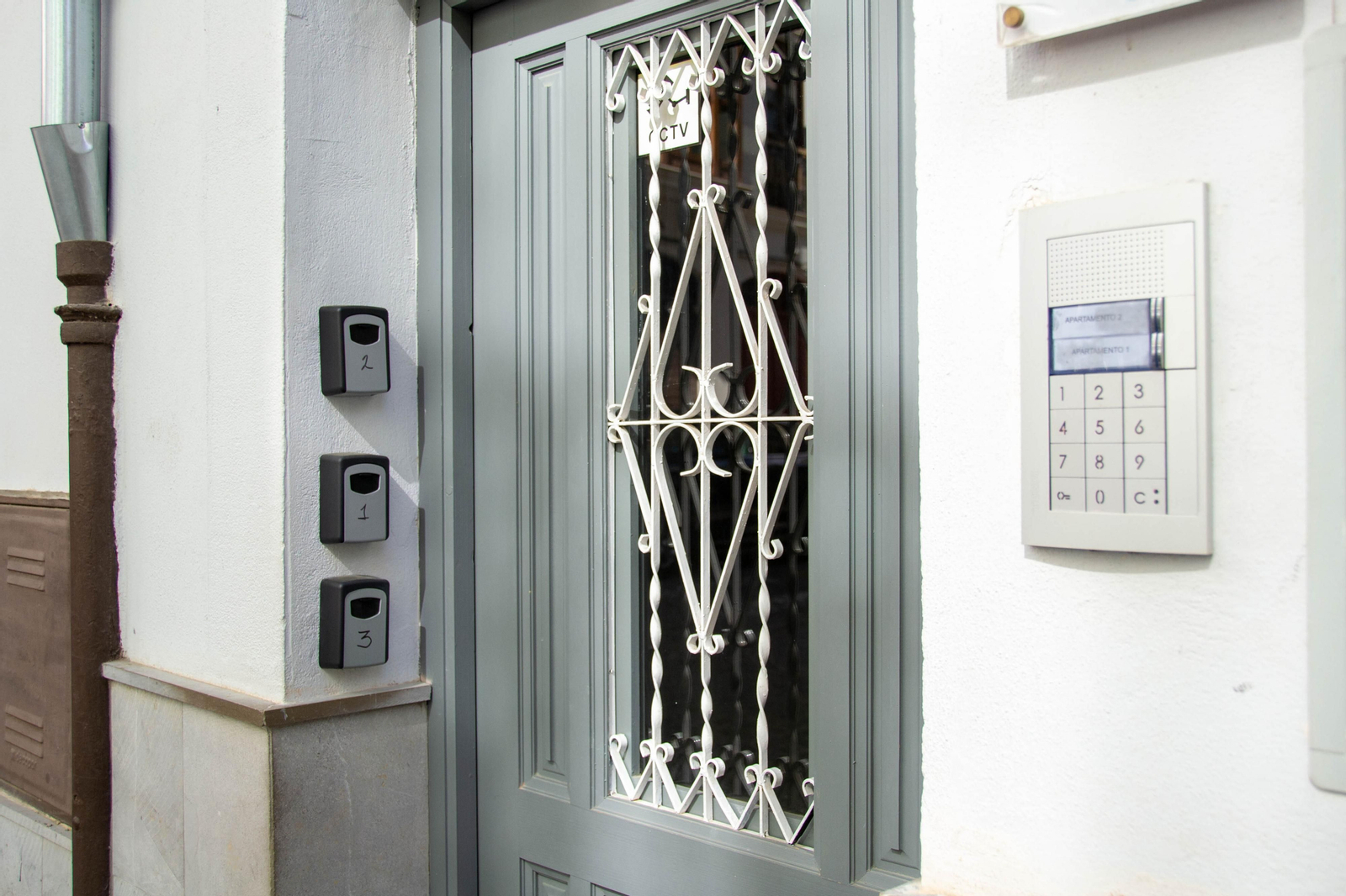 Cajetines de seguridad para llaves en la puerta de entrada a un edificio con viviendas turisticas.