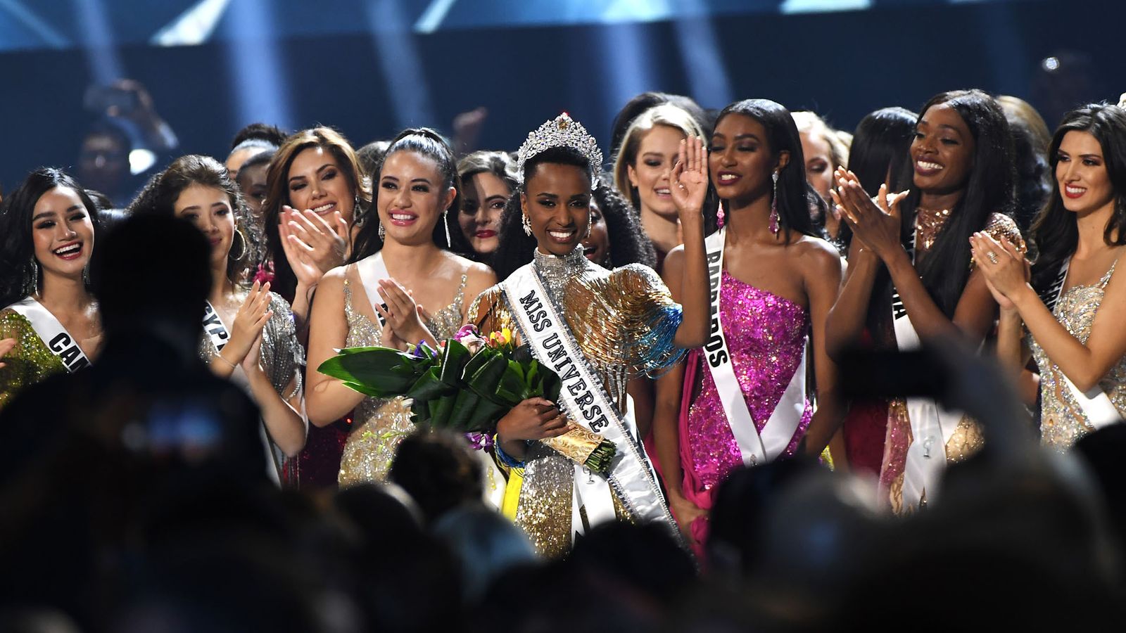 'Miss Universo' saluda tras su proclamación rodeada del resto de apirantes.