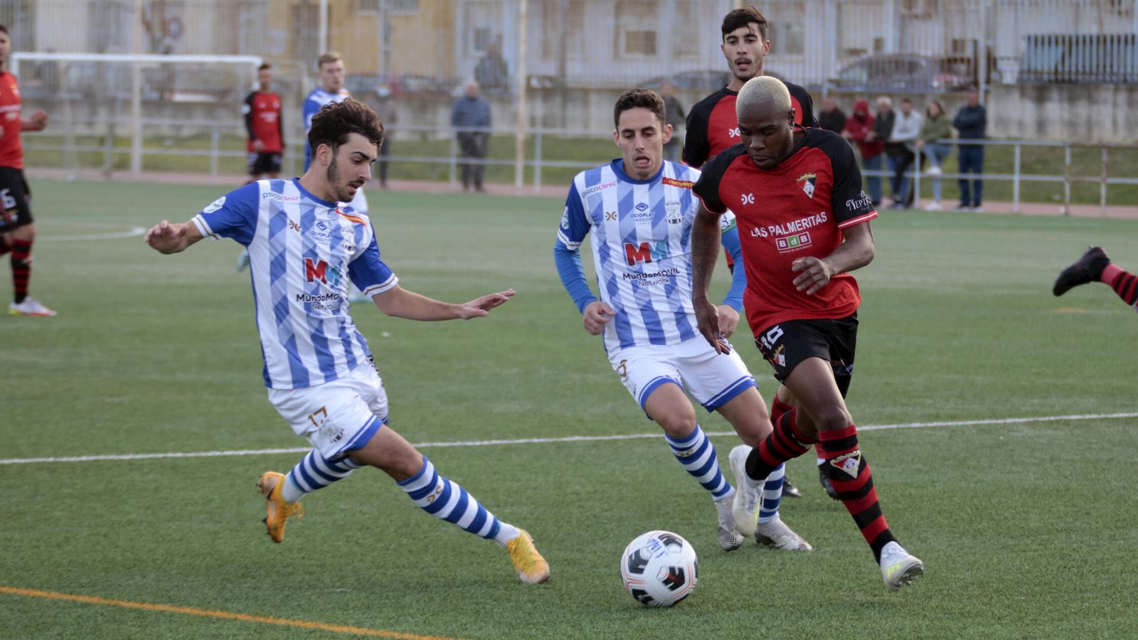 Mateo intenta que un rival, junto a Caballero, no llegue al balón.