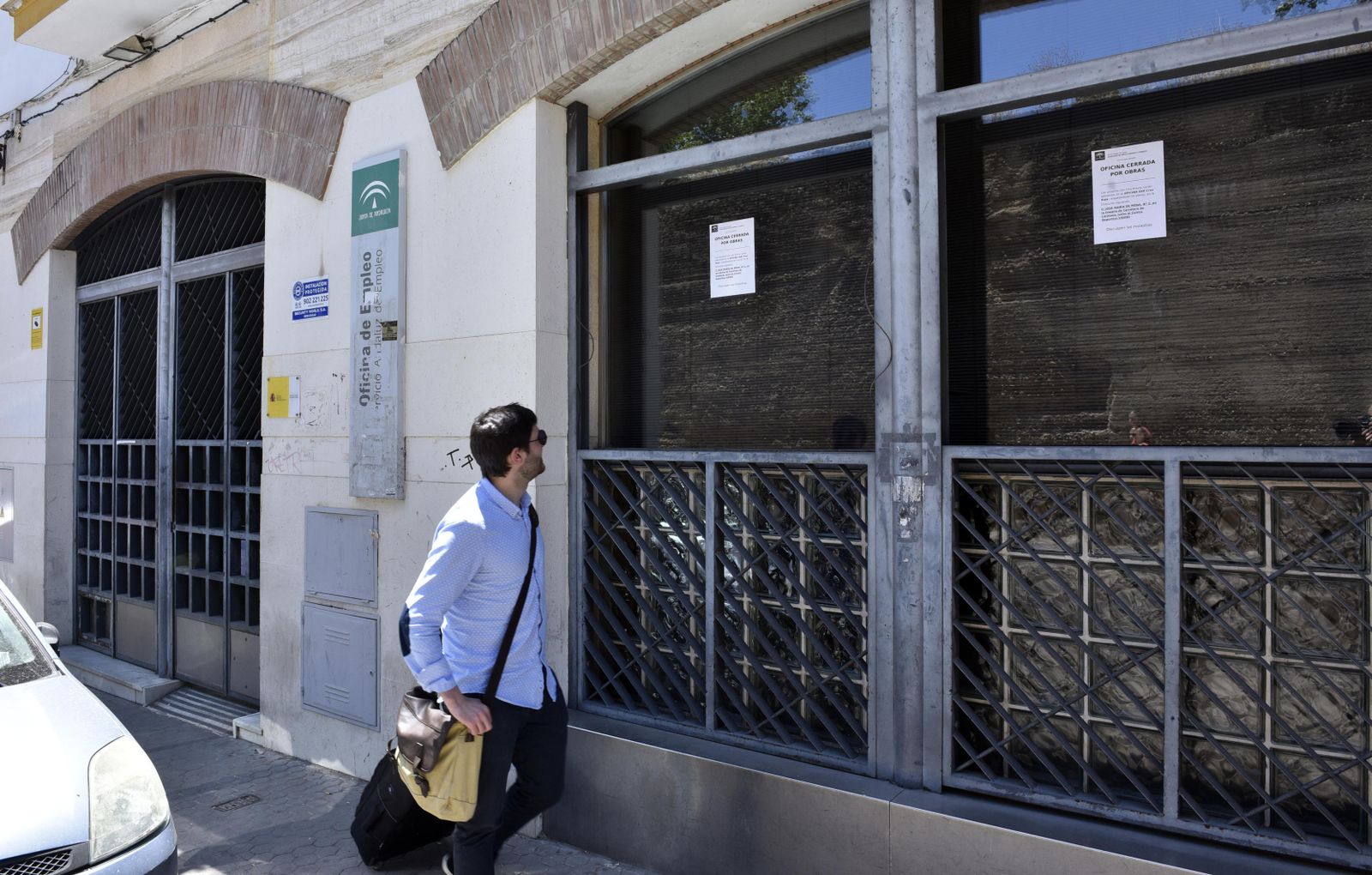 Un hombre lee el cartel que informa del cierre de la oficina de empleo de la Macarena, ayer.