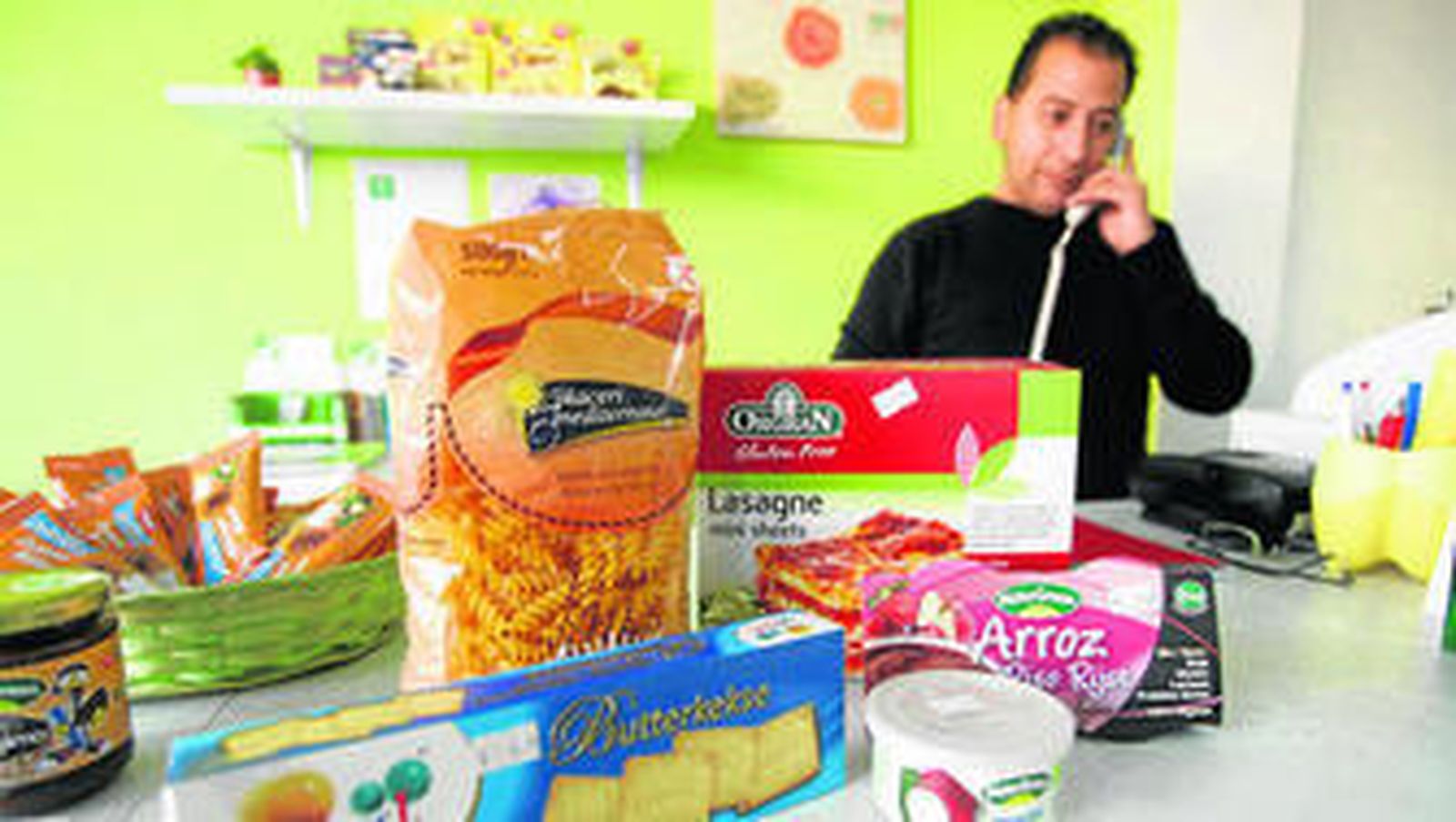 Jesús Lachica, al fondo, junto a algunos de los alimentos de la tienda.