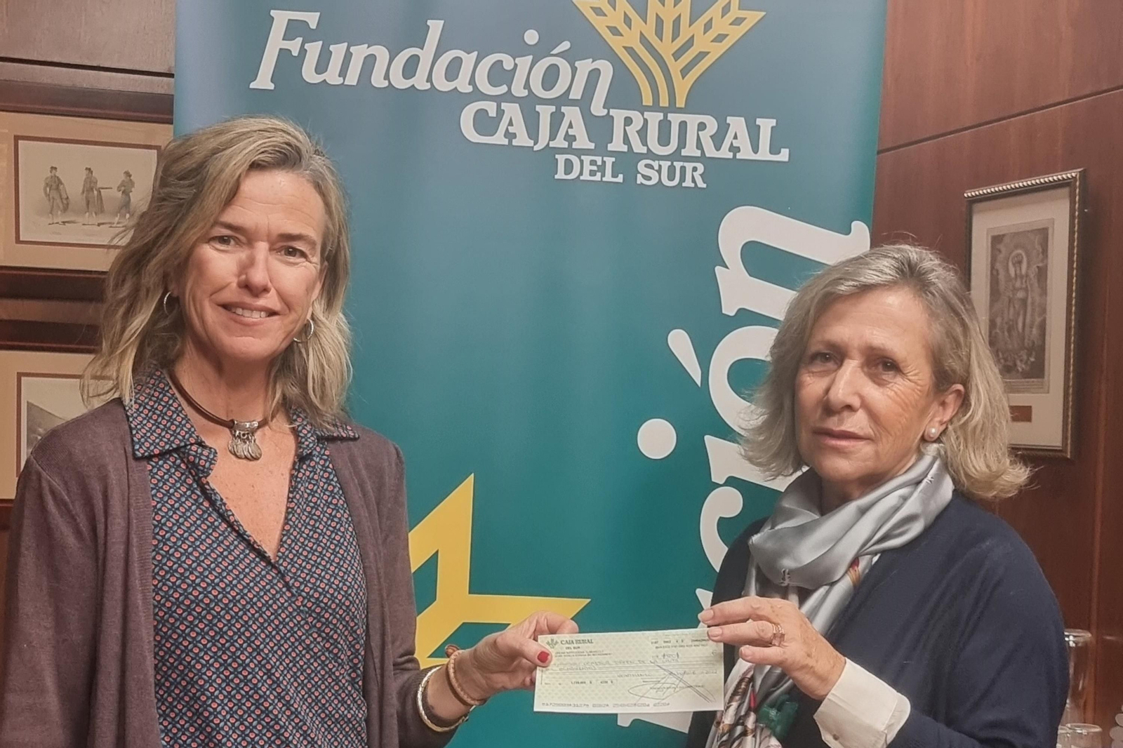 Entrega del talón de la recaudación a la representante del Comedor Virgen de la Cinta